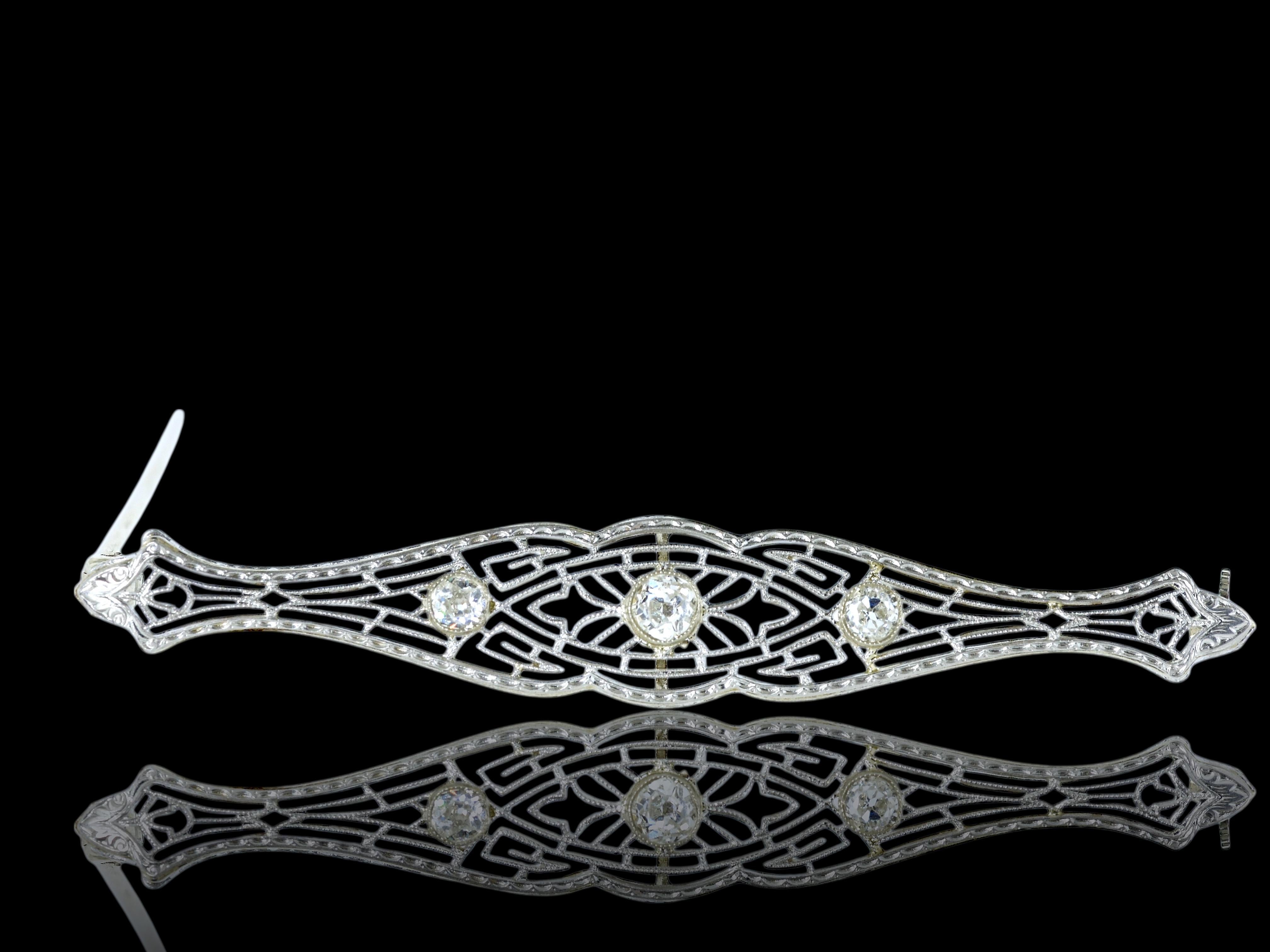 Antique gold and diamond filigree bar pin, the three diamonds are bezel set in the center.  The estimated weight of these 3 old cut diamonds is .35 cts.  This pin is 2.5 inches in length with a secure locking clasp, which is marked 14k.  In fine