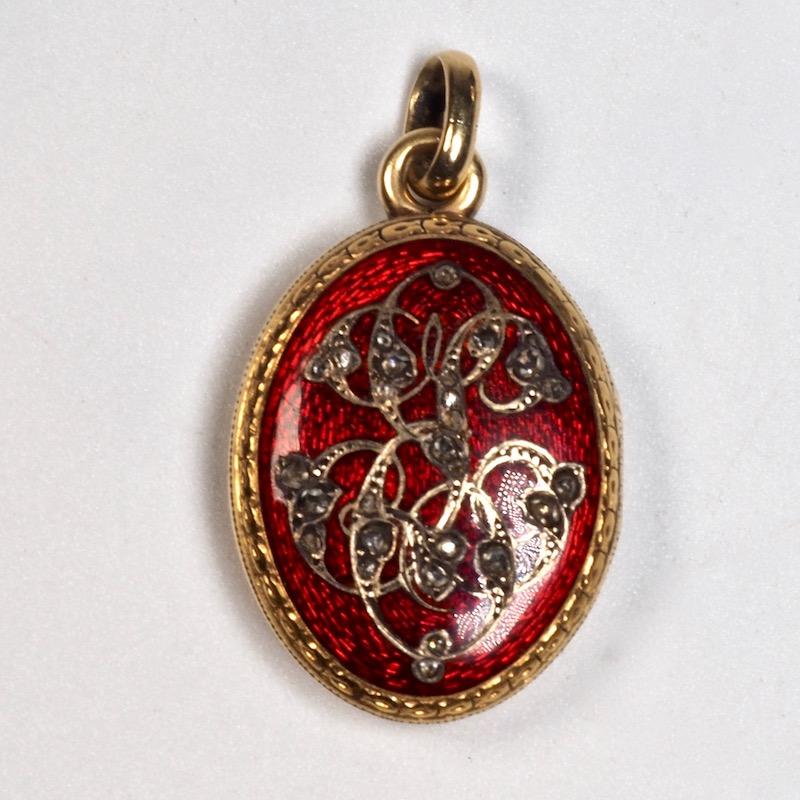 Antique gold and rose cut diamond guilloche enamel locket with scrolls and rose-cut diamonds, opening to a hairwork compartment.