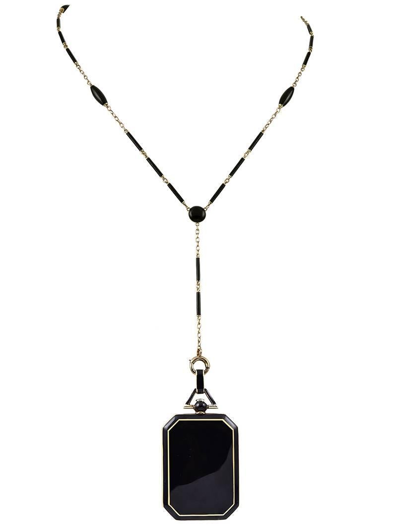 Elegant and beautiful double-sided locket.  Rectangular shape with cut corners.  14K yellow gold and black enamel, with gold detailing.  Opens to reveal bezels for two pictures.  On original gold and enamel 20