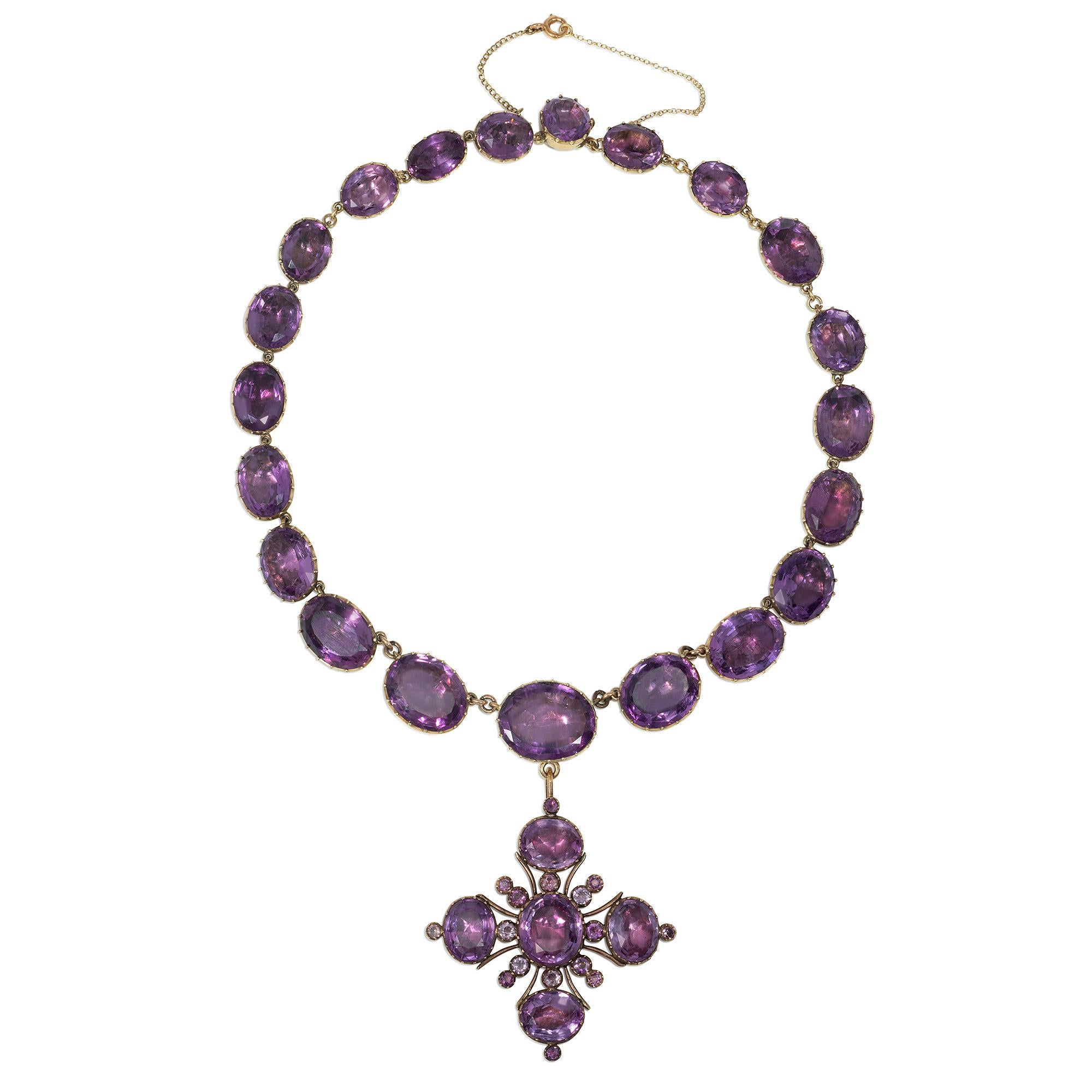 An antique Georgian period amethyst rivière necklace comprising graduated oval foil-backed amethysts, suspending a detachable gold and amethyst maltese cross pendant, in 14k.

Dimensions: necklace 15