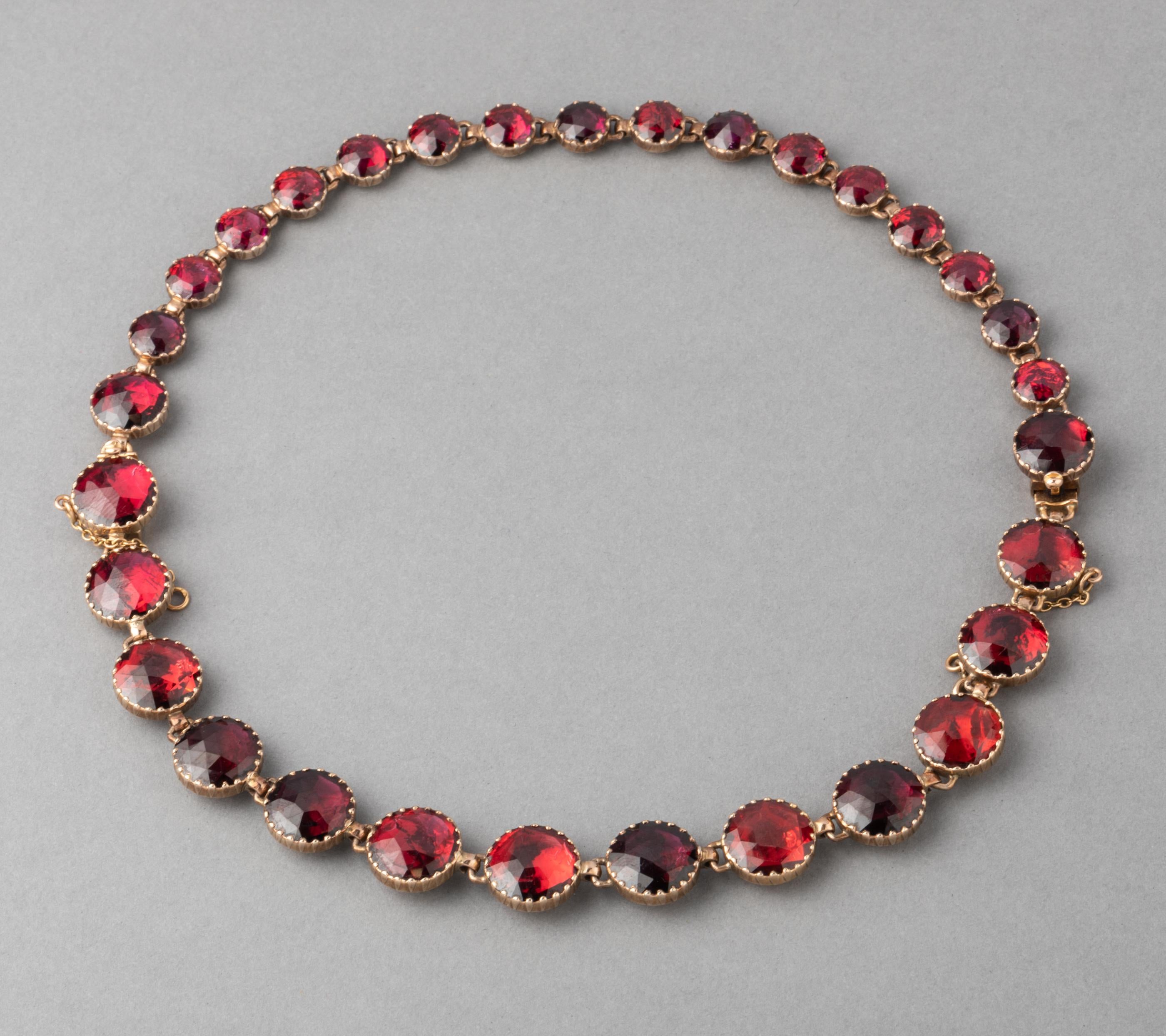 Antique Gold and Garnets French Necklace

Very beautiful antique necklace, made in France circa 1880. 
Made in rose gold 18k, horse head mark. Set with beautiful red garnets, they are good quality, the color is intense and very clear