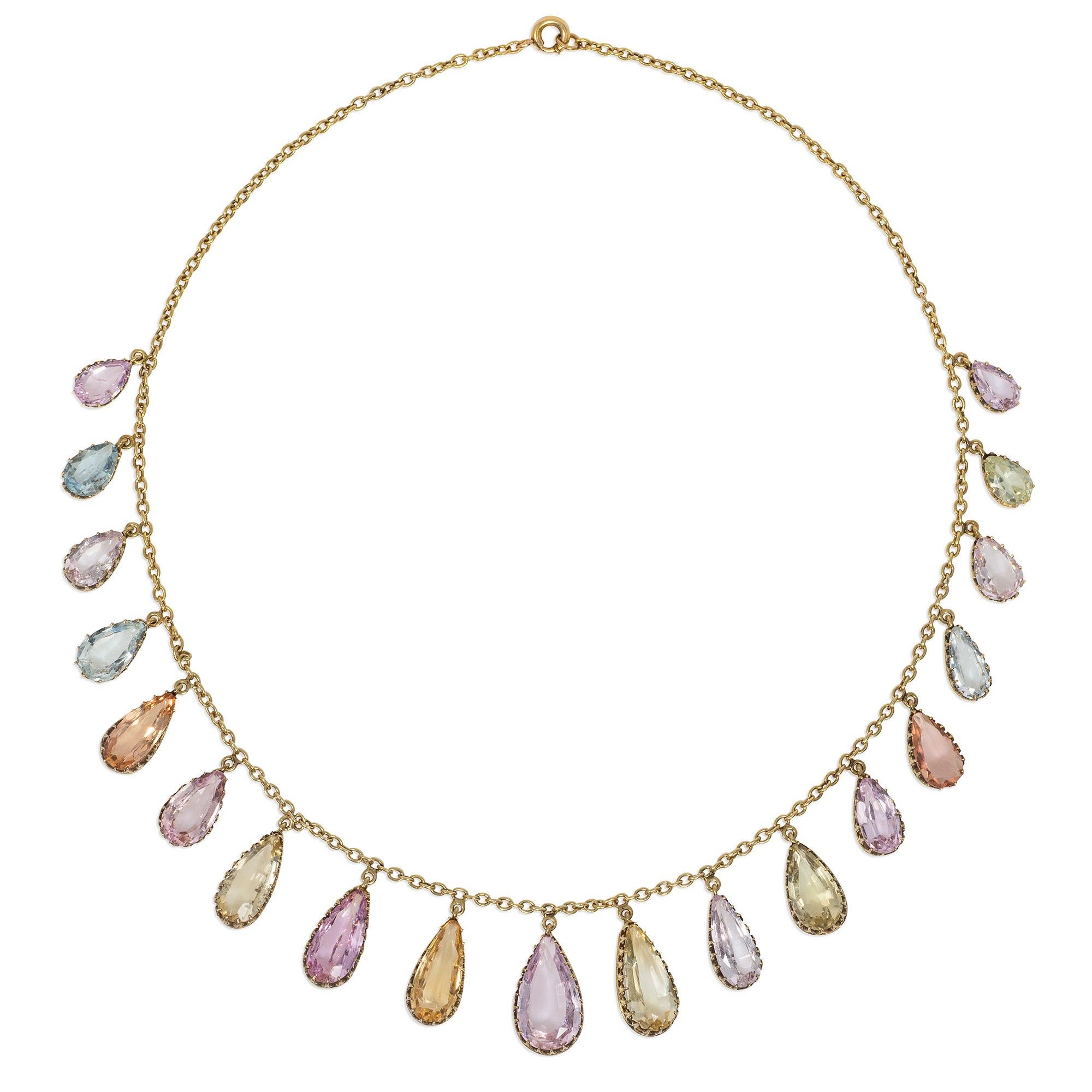 An antique Victorian period gold and topaz necklace of fringe design, comprising graduated precious topaz pear-shaped drop pendants in an array of pastel colors, in 14k.  Largest stone measures approximately 16mm long x 10mm at widest point;