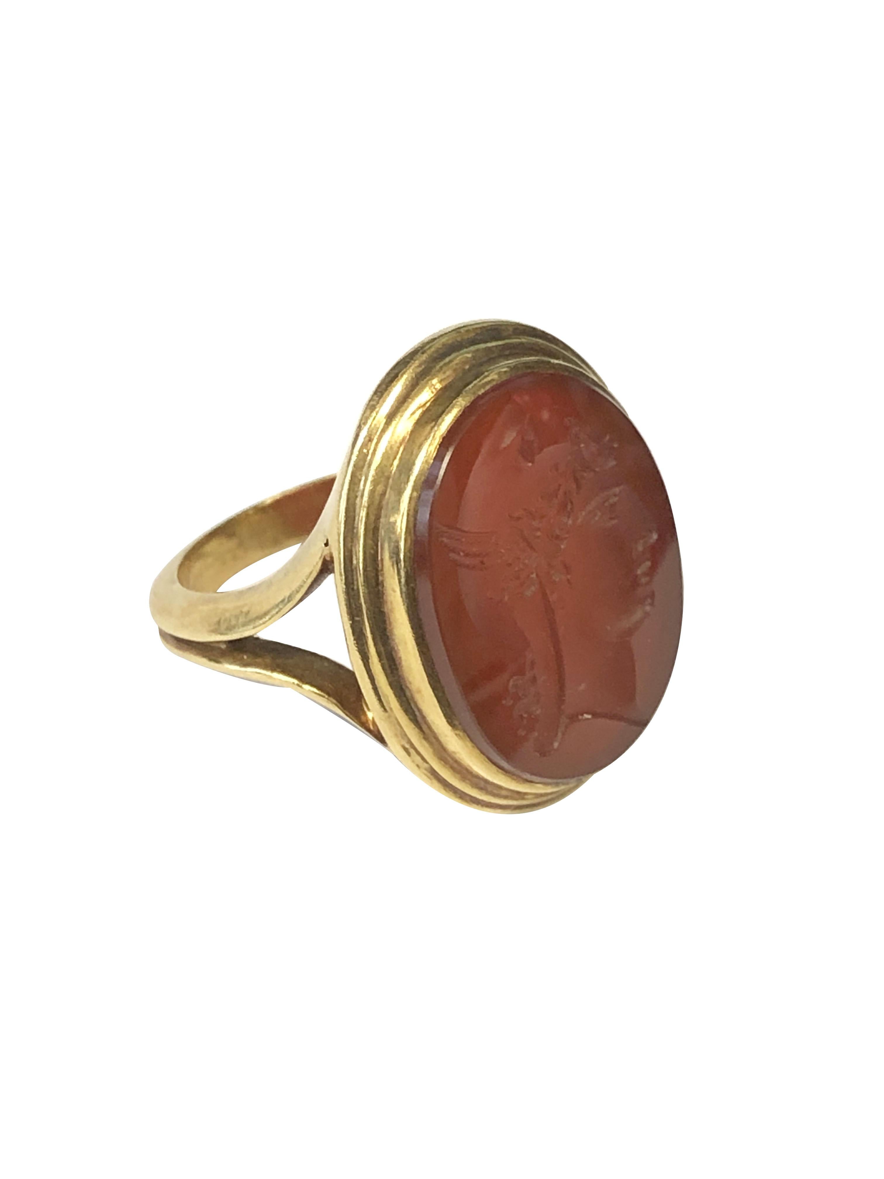 Circa 1880 - 1890 14k Yellow Gold Intaglio ring, measuring 15/16 x 3/4 inch and is set with a Carnelian stone with a deep carving depicting a Roman Greco style figure. Thick and heavy bezel and shank, finger size 8 3/4.  