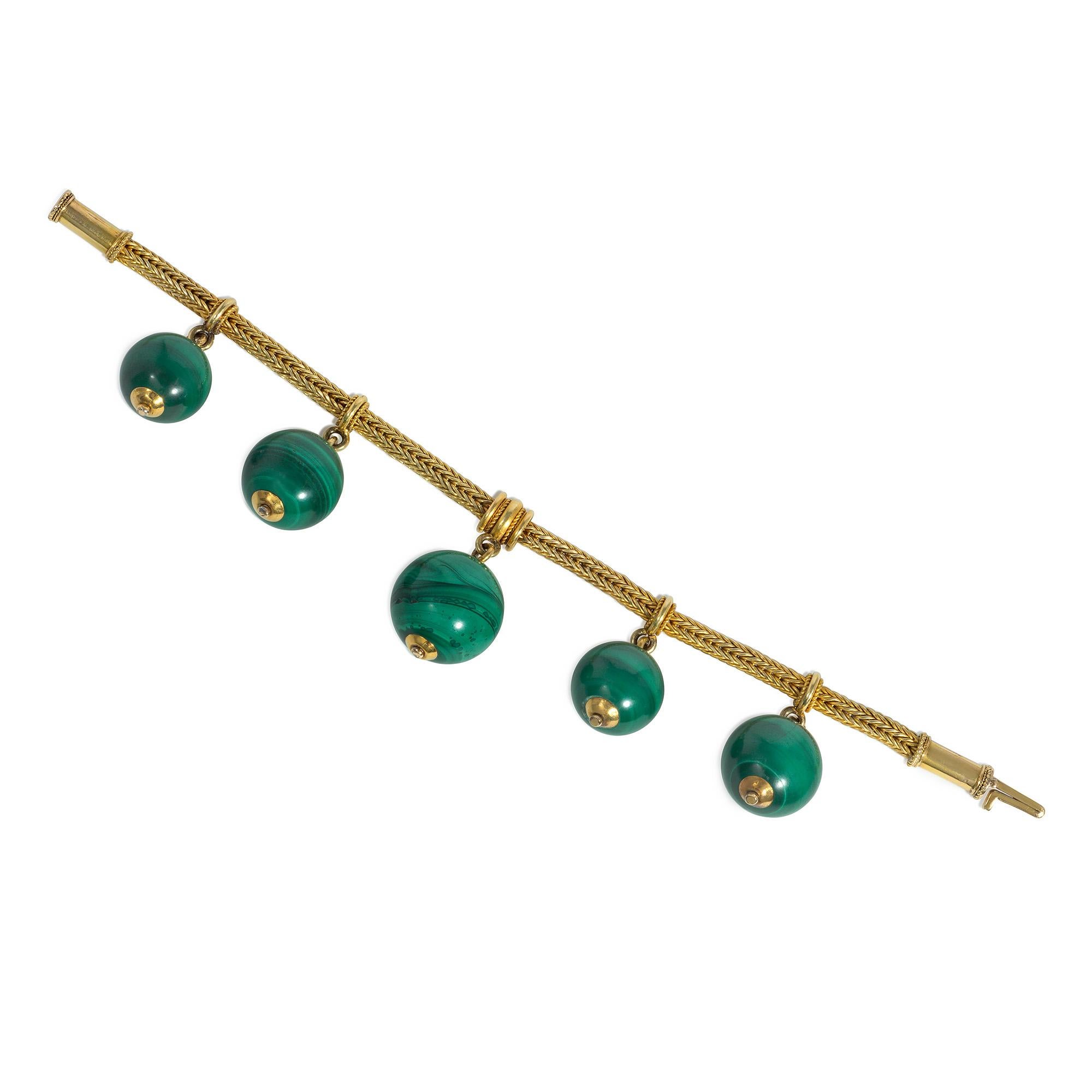 An antique Victorian period gold and malachite bracelet in the Etruscan Revival style, comprised of a gold foxtail chain suspending five malachite beads of varying sizes from gold rings with rope twist accents, completed by a hinged, barrel clasp,