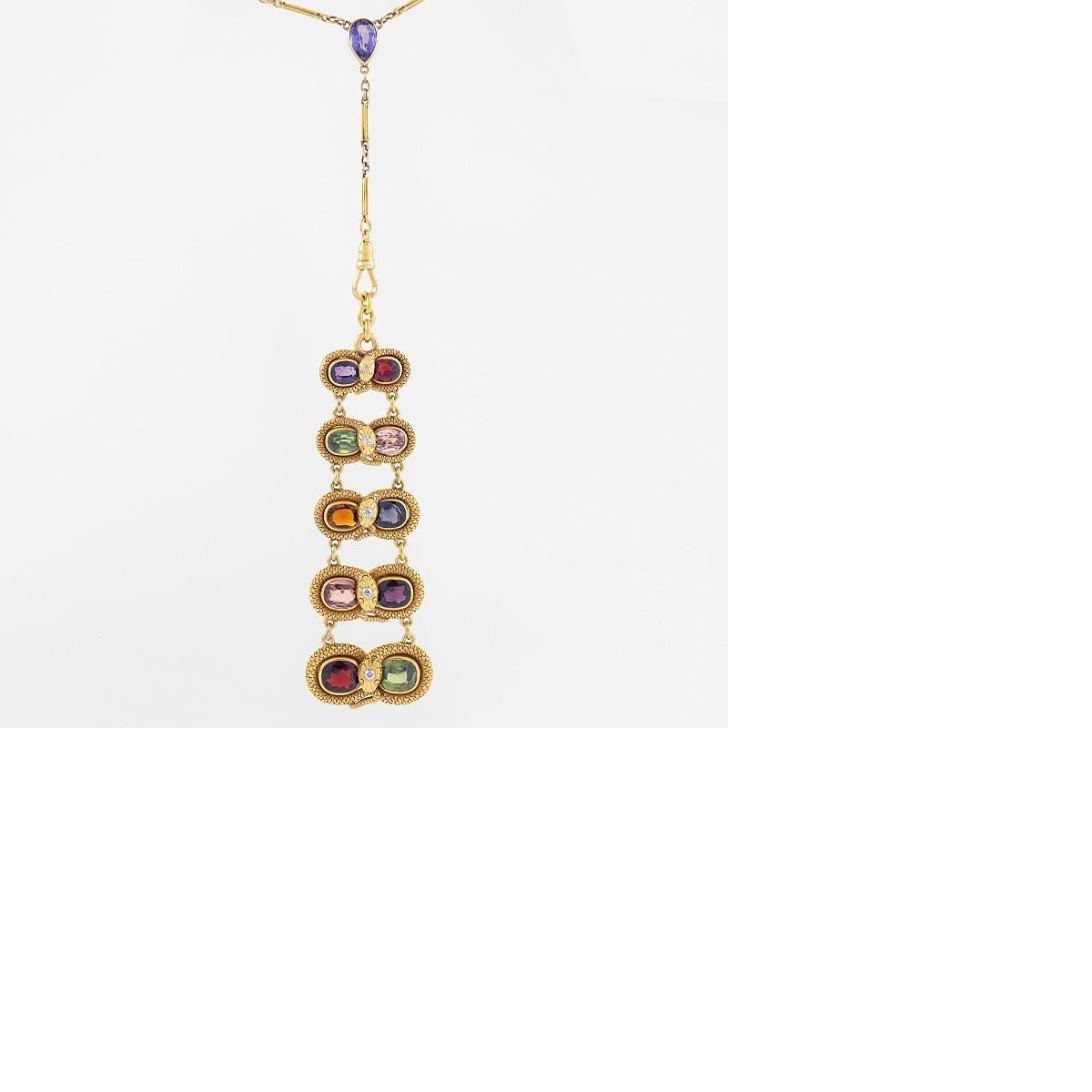 A 14 karat gold and colored stone-studded chain featuring a 10 stone pendant with a snake motif. This turn-of-the-20th-century pendant is comprised of five horizontal links that graduate in size and are connected with flexible joints. Each of the