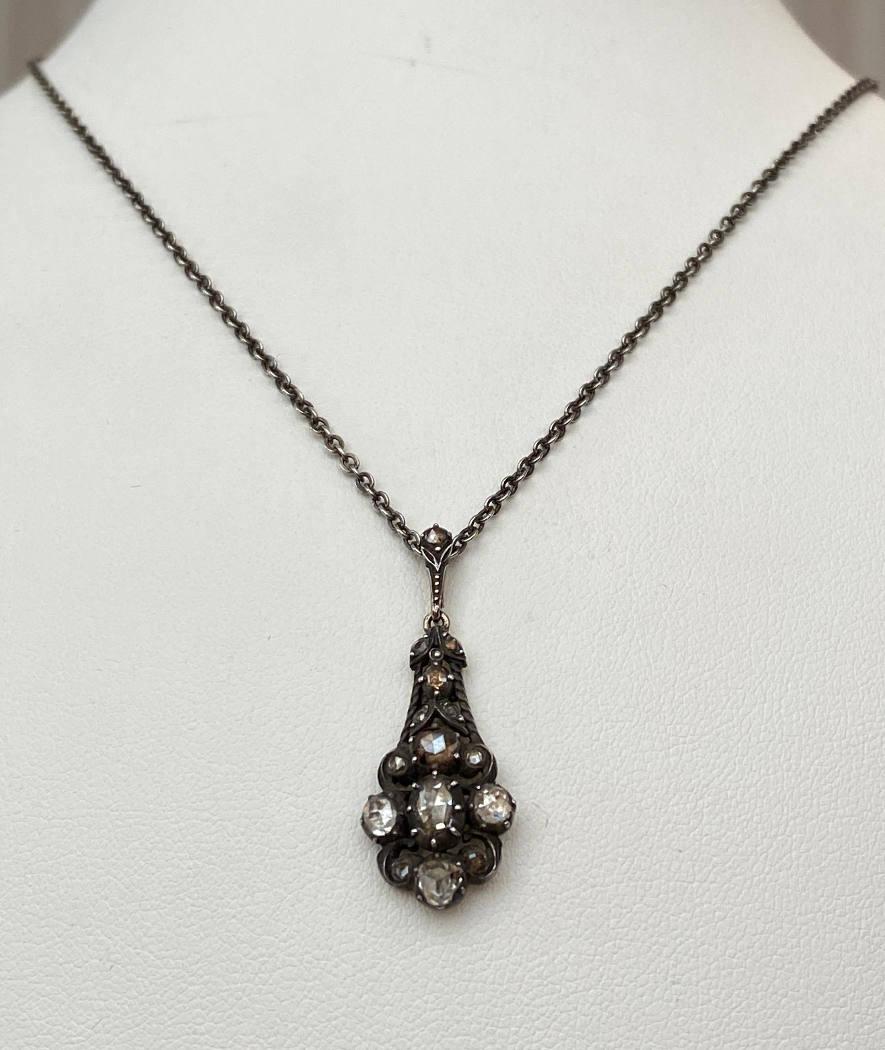 The 14 kt gold/silver pendant is set with a 18 stones rose- cut diamonds, weight estimated to be approximately 0.80 Ct. The diamonds are mounted on foil in closed setting. Pair diamonds looks like brown due the foil color changes.  Victorian work