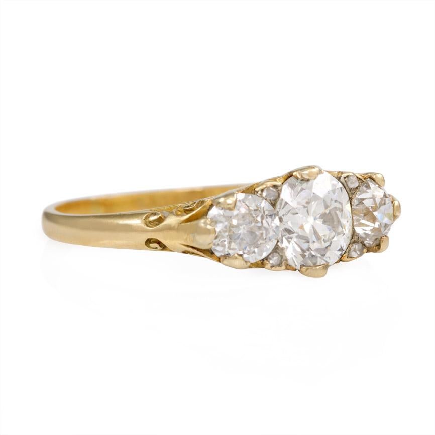 A late Victorian half hoop three-stone diamond ring in a carved foliate mounting, in 18k gold.  Atw 1.36 ct.  Works beautifully as an engagement ring!

Top measures approximately 14mm across finger
Current ring size: US 8 1/4 - 8 1/2 (Please contact