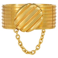 Bracciale Bangle in oro antico con medaglione centrale e accenti di catena