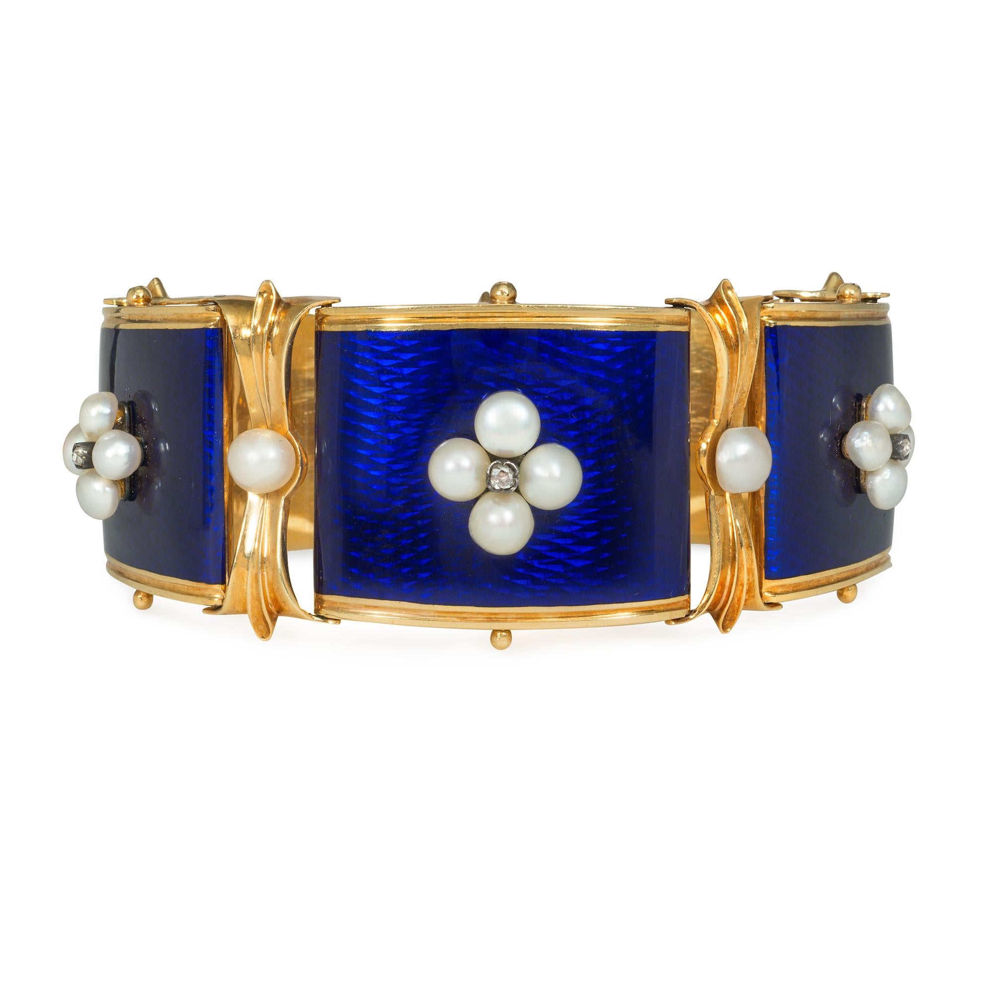 An antique Victorian gold, enamel, pearl, and diamond bracelet comprised of five tapering blue enamel plaques set with quatrefoil pearl and rose diamond elements, with foliate motif and pearl spacers, in 18k with double locking box clasp. French
