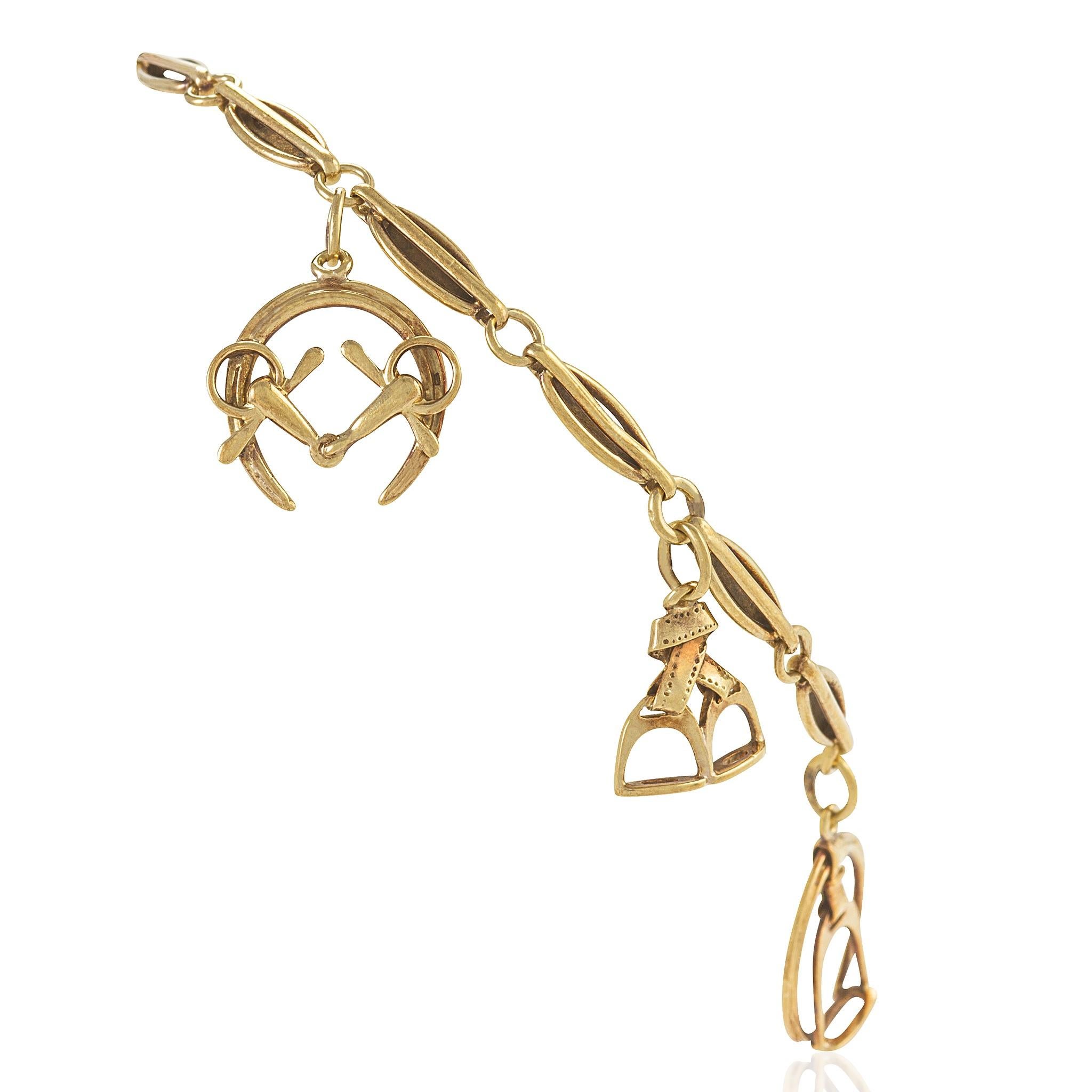 An antique 14 karat gold bracelet with horse charms. The oval fancy link chain suspends a variety of equestrian charms including stirrups with leathers, horseshoes, snaffle bits, and a horse on a lunge line 