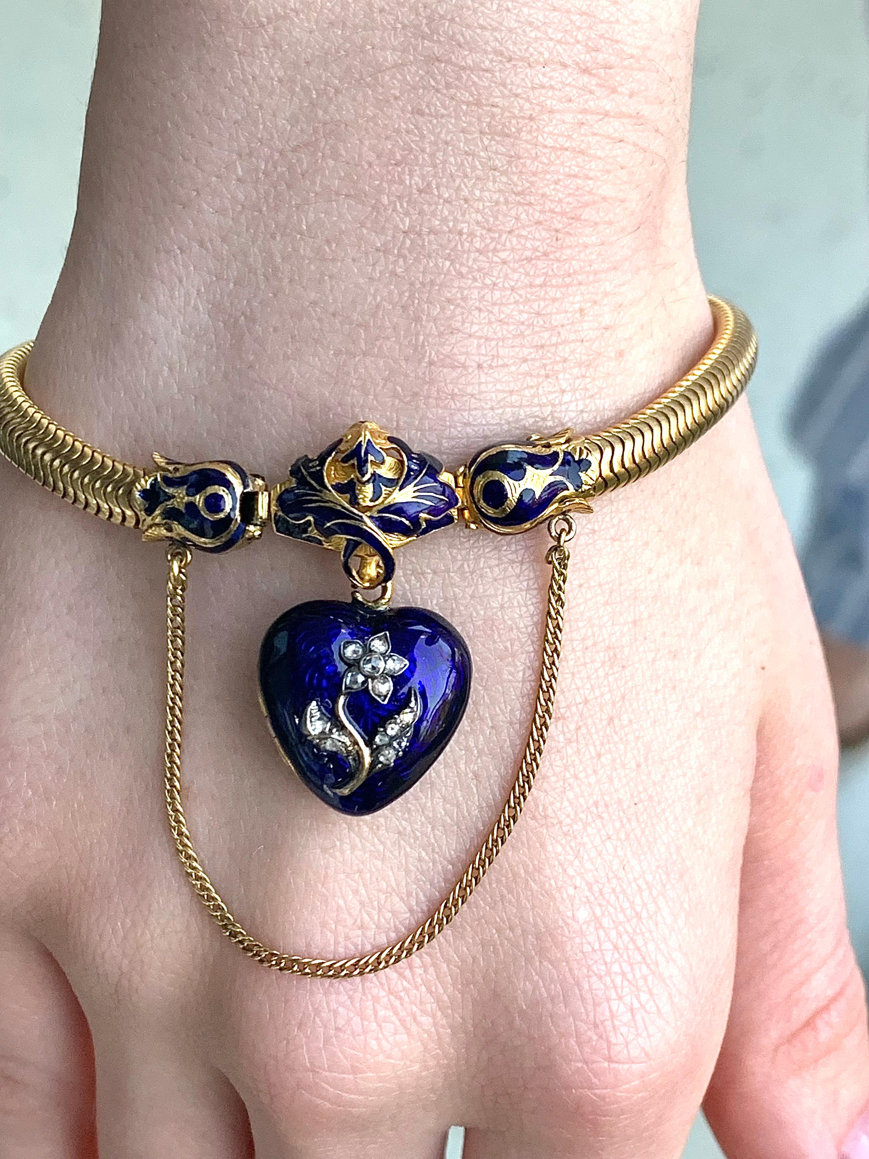 This flexible bracelet was hand crafted out of 18 karat gold in the middle of the. 19th century. The ends of the articulated gold braceletd terminate in a  blue enamelled clasp. A blue enamelled heart with locket back is decorated with a diamond set