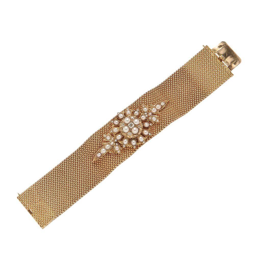 An outstanding antique wide strap bracelet consisting of 14K Gold, Split Pearls, and old-mine cut diamonds. Boxed.