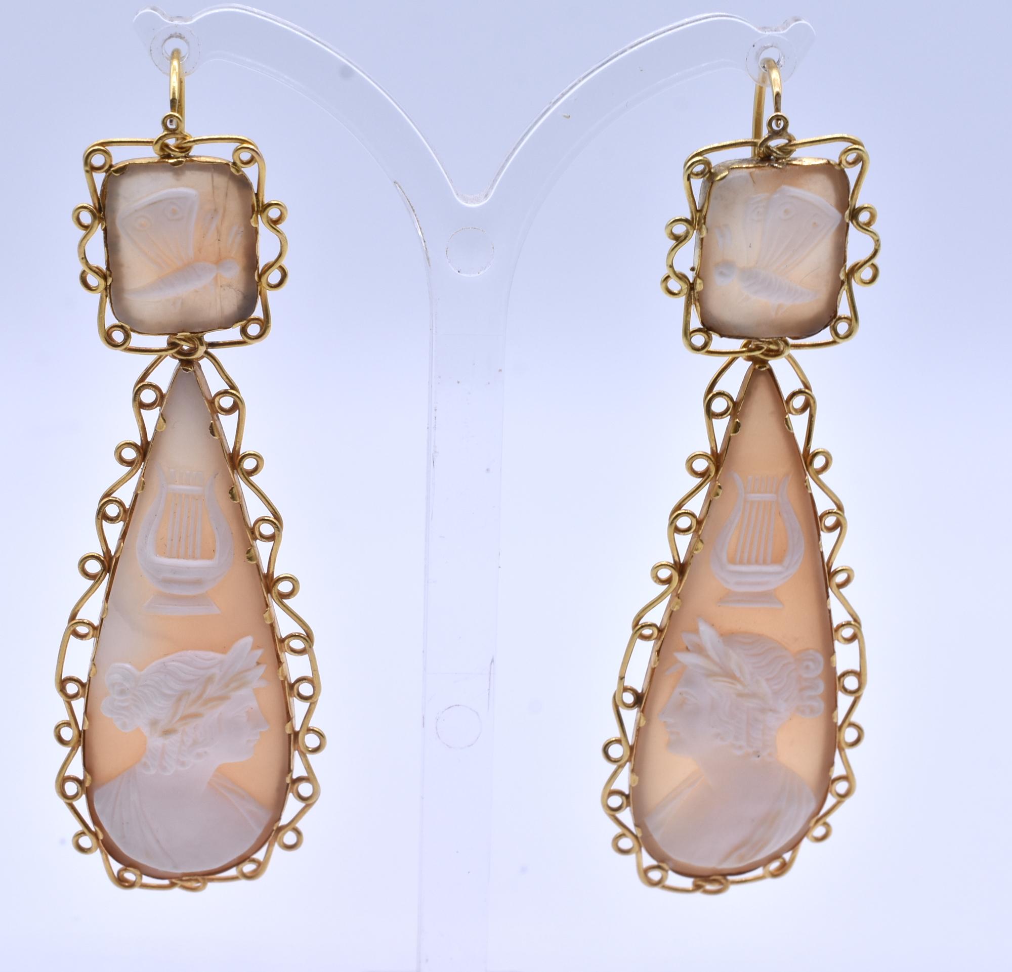 Lovely day/night shell soft pink cameo earrings bordered with delicate 18k gold loops and a carved depiction of Apollo,  god of the Arts in Greek and Roman mythology. iApollo represented culture and civilization and was the image of male beauty as