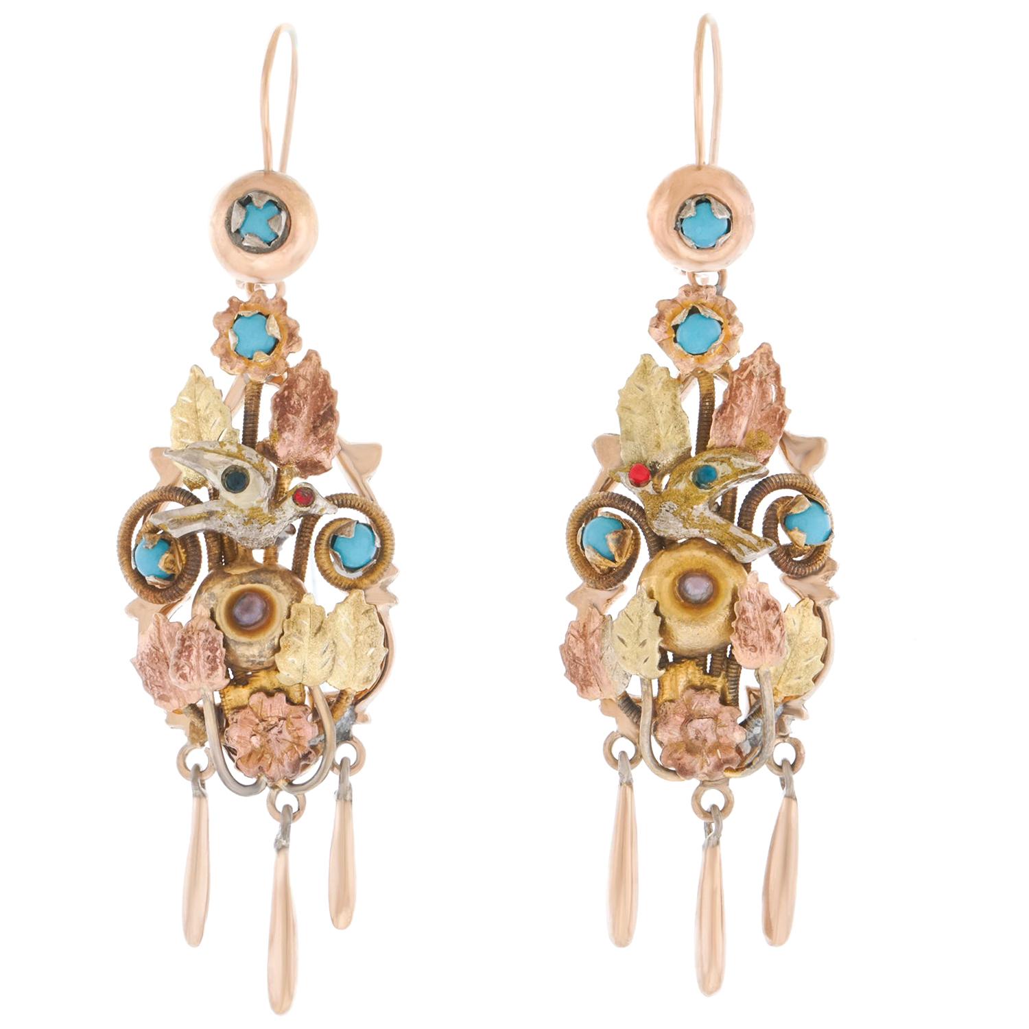 Circa 1890s, 14k,  Attributed Italy.   These elegantly insouciant Victorian earrings feature a riot of birds, leaves, flowers, and swirls set with colored stones and glass. Fashionably chic period Italian design, they pair effortlessly with a