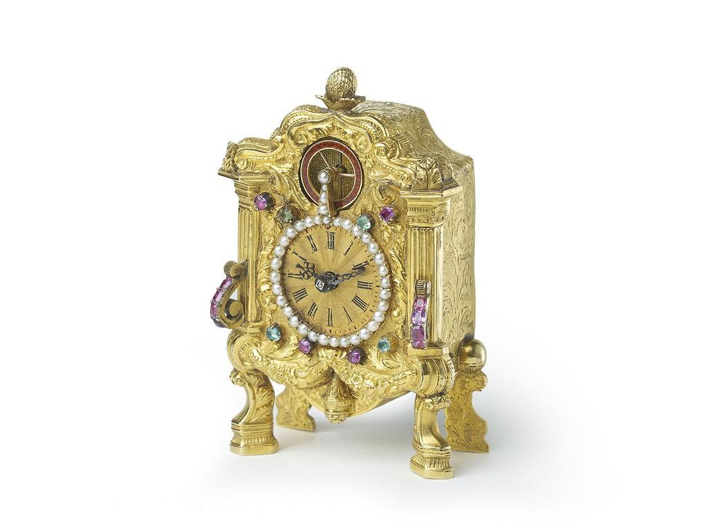 A Viennese miniature gold zappler carriage clock probably by Carl Wurm, with a repoussé, chased and engraved case, designed as a small bracket clock, with the front face finely chased with garlands of flowers and acanthus, with scrolling foliage,