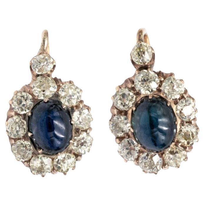 Antique gold earrings with diamonds and sapphires in cabochon cut.
