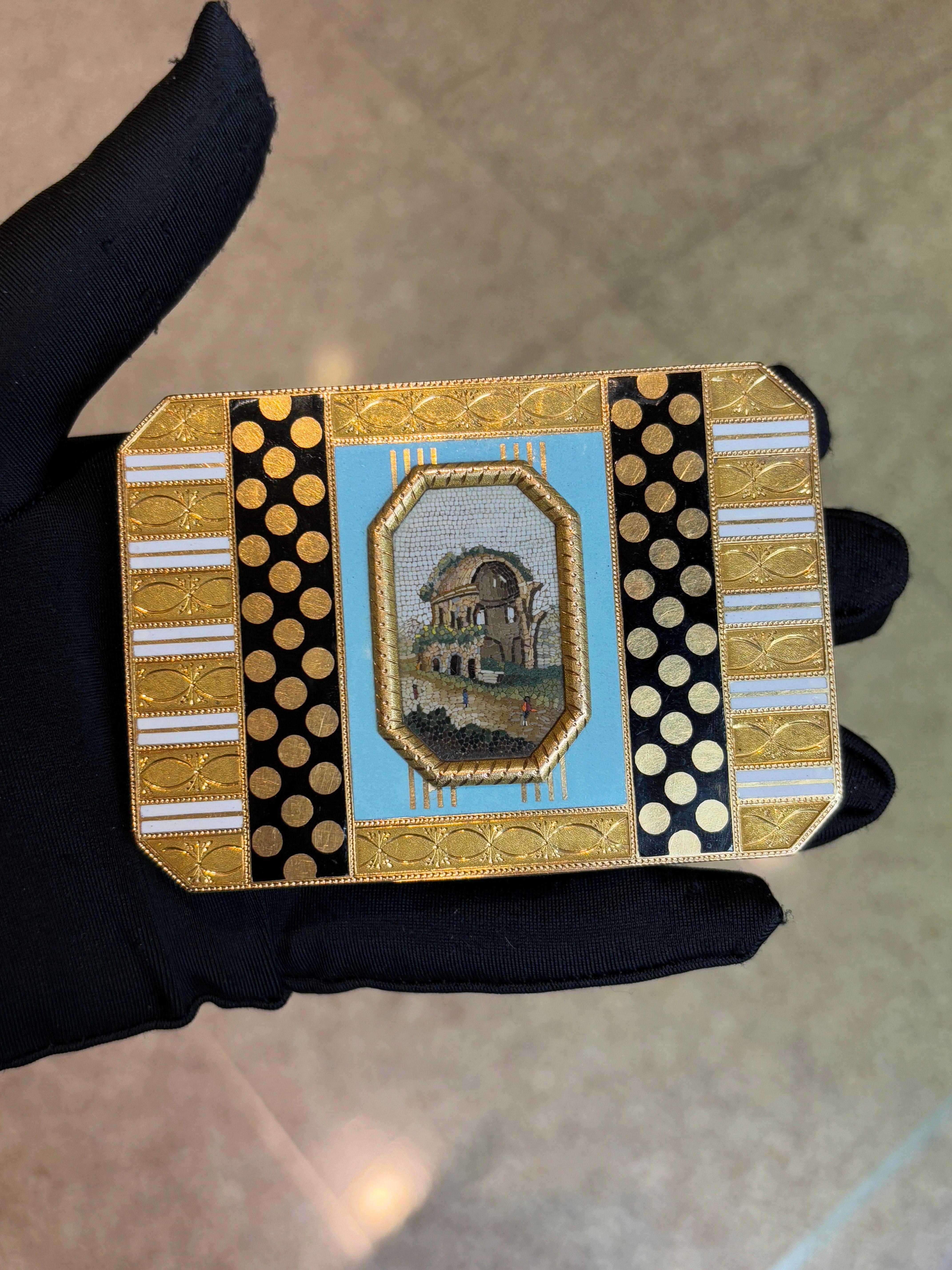 Antique Gold & Enamel Micromosaic Snuff Box

An antique snuff box, decorated with a central micro­mosaic panel depicting ruins. The scene is framed by turquoise enamel, with gold-dot black enamel bands and white-and-gold striped borders. 

Circa: