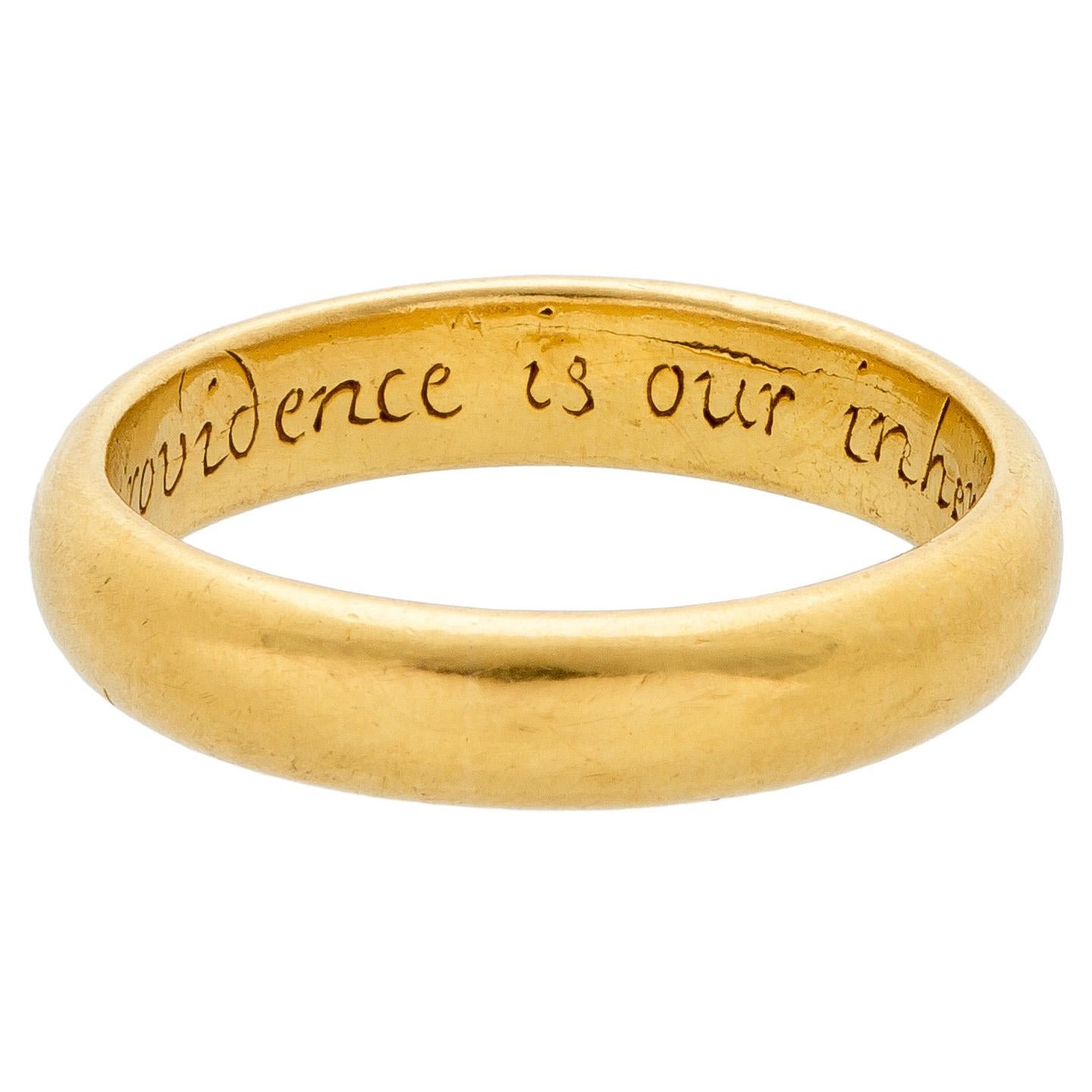 POSY RING “GOD’S PROVIDENCE IS OUR INHERITANCE”
England, 18th century
Gold
Weight 8.2 gr.; circumference: 60.38 mm.; US size 9.25; UK size S ½

The plain gold band with D-section has on the interior the engraved inscription in italic lettering