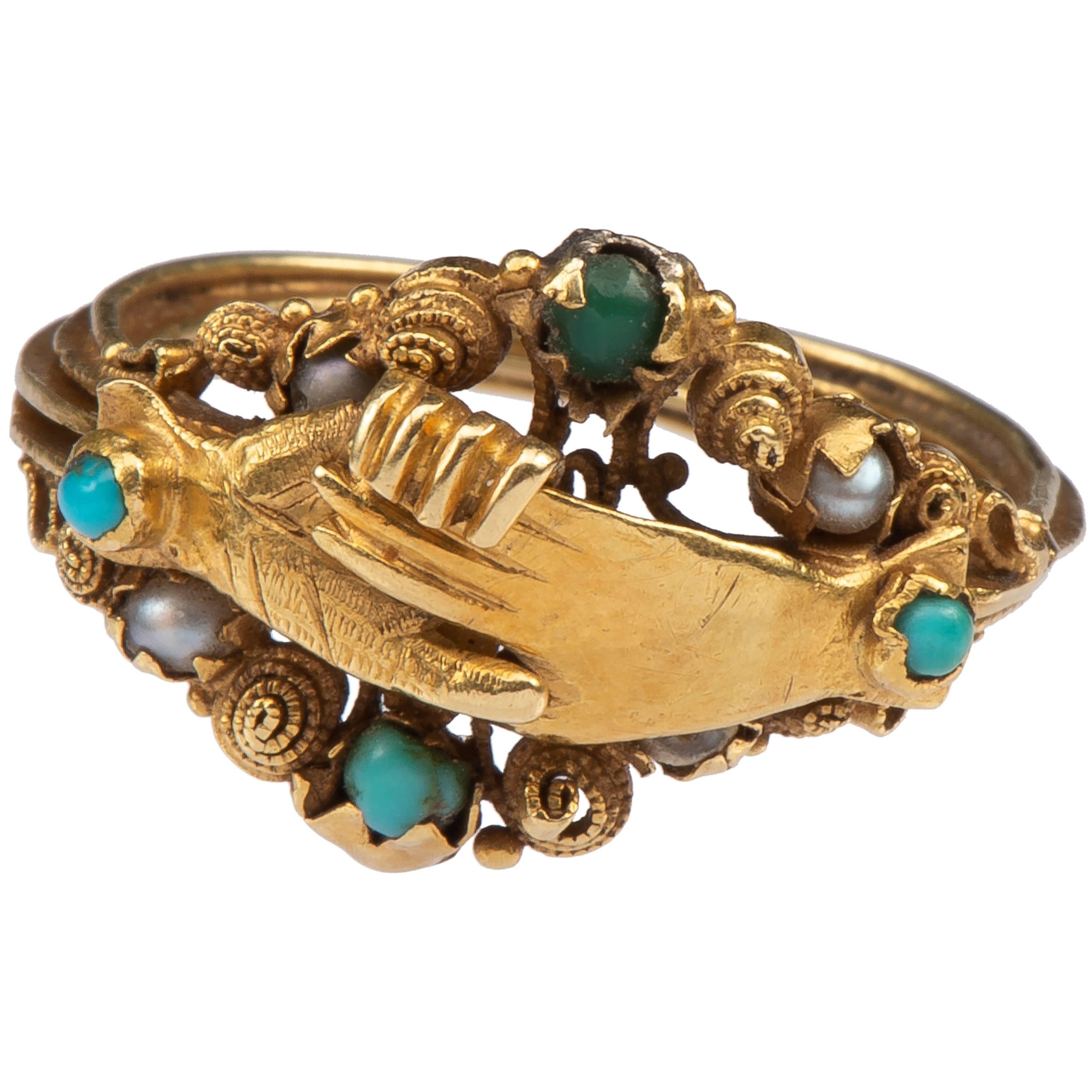 Gimmel Fede Ring
French, c. 1820-1830
Gold, turquoise. pearls
Weight 3.8 gr; Circumference 47.97 mm; US size 4 1/2; UK size I ½
	
Description:
The gold ring is composed of three connecting hoops attached by a hinge. The central hoop bears a cross