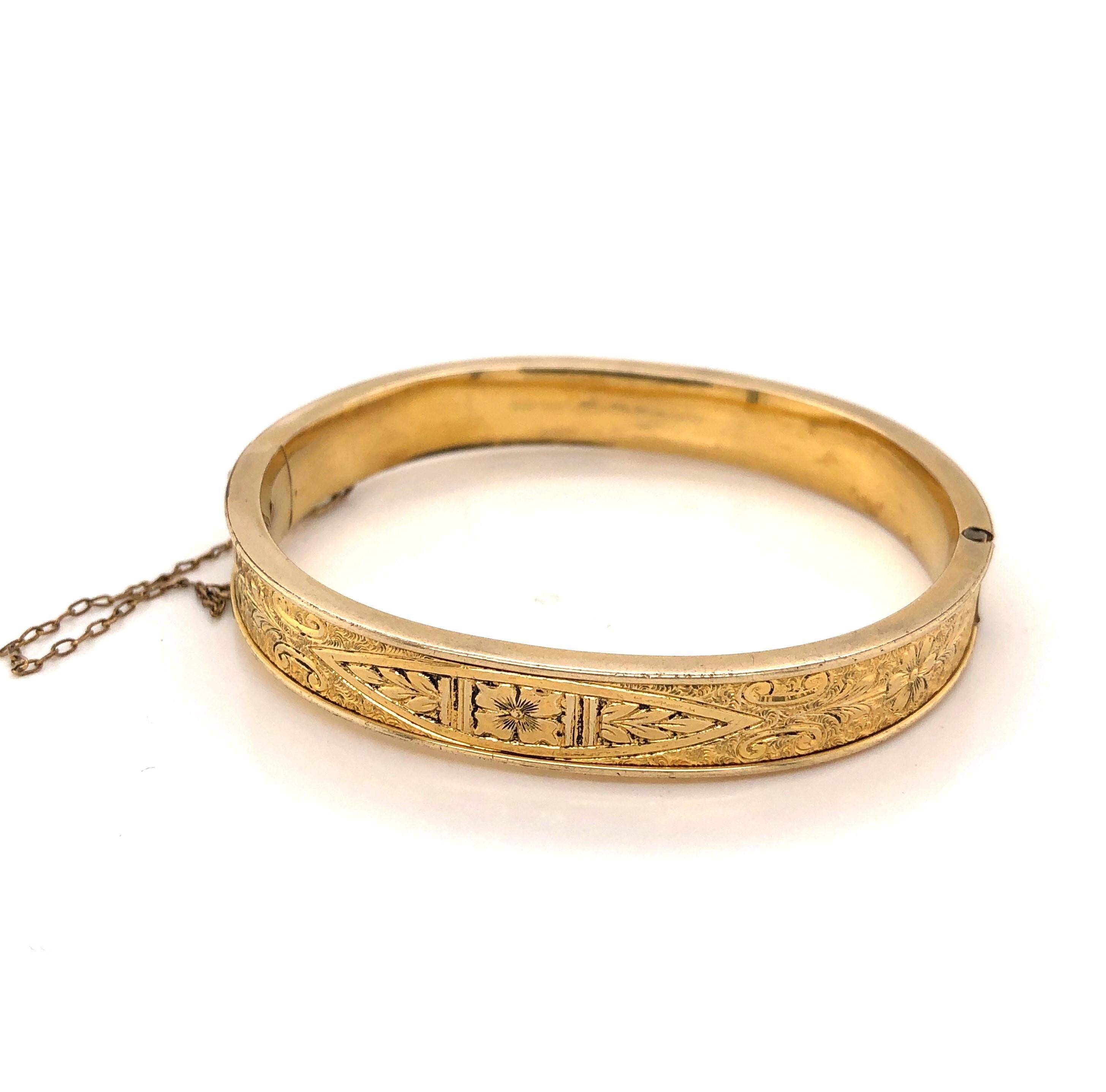 A special gift for the little lady in your life. Fancy pressed engraving decorates this darling ten carat gold filled bangle bracelet. The inside measurement is 2 x 13/4 inches and the width of the band is 1/4 inch. With hinge for wear, the piece is