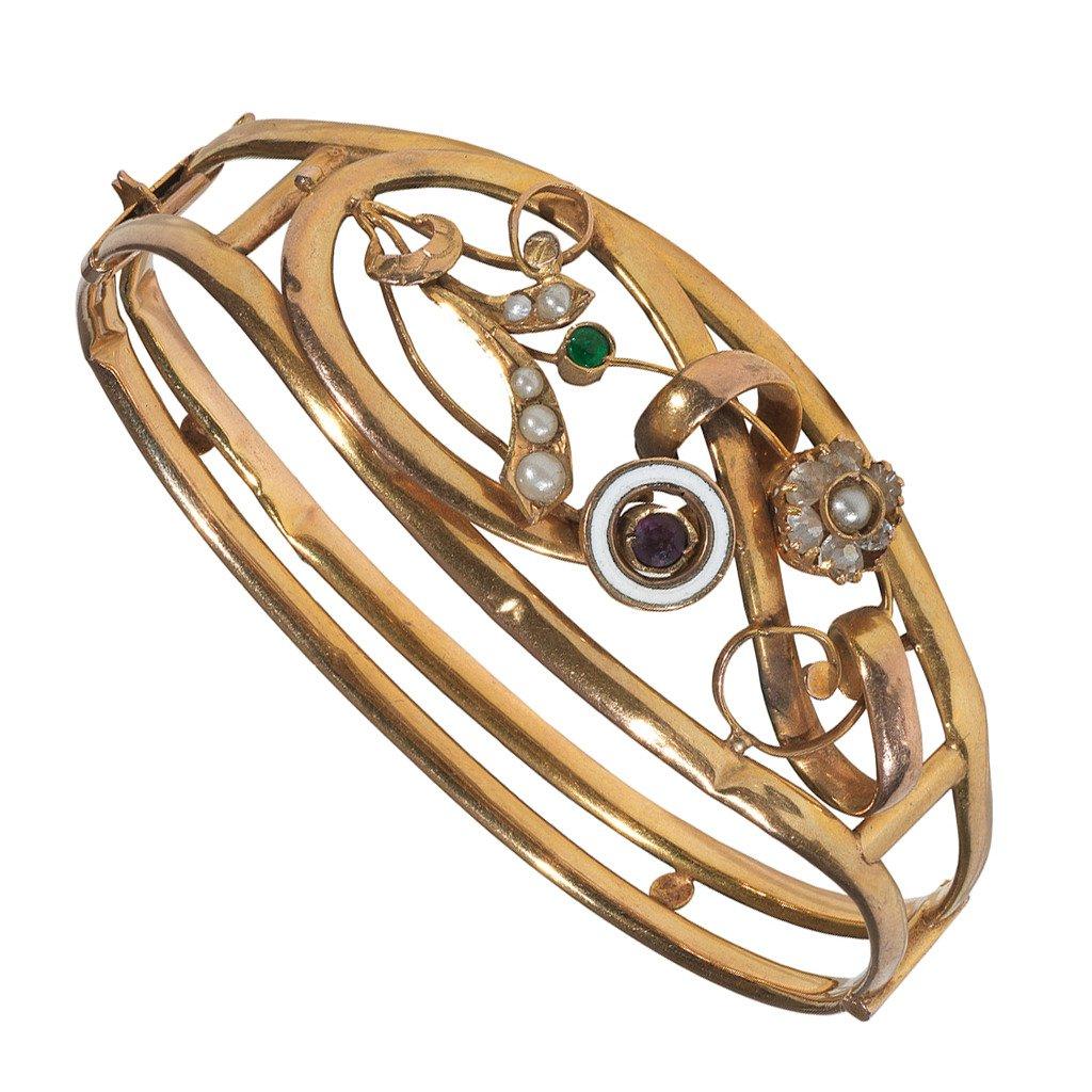 
Designed as a delicate stylized floral motif accented by a green tourmaline, crystals, pearls and an amethyst enclosed in a white enamel border.  Mounted in yellow gold.

The bangle is hinged and opens. 

Inner diameter: 61 mm

Italy, circa 1860