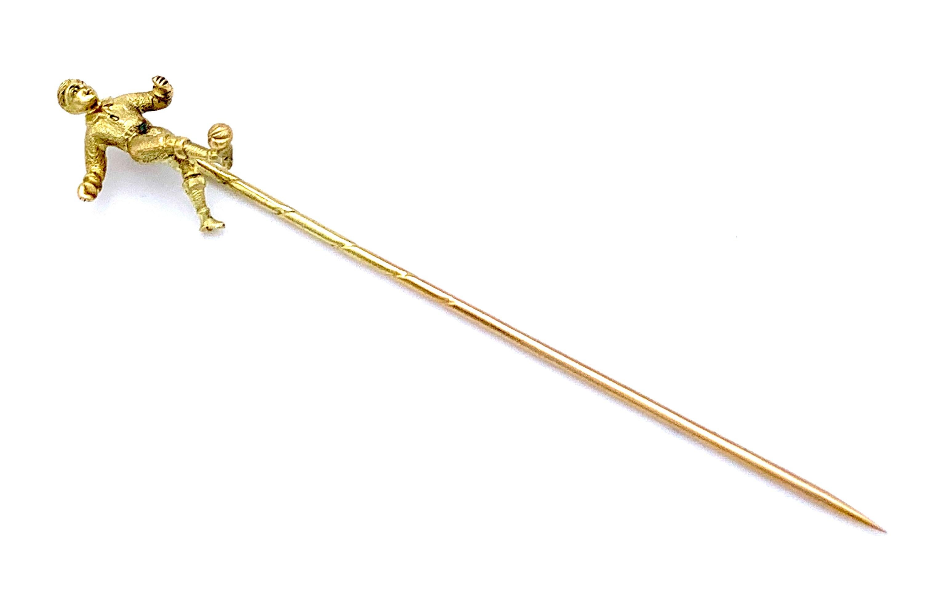 This wonderful and unusual 14k gold stickpin shows a beautifully modelled figure of a soccer / football playerabout to kick his ball. 
