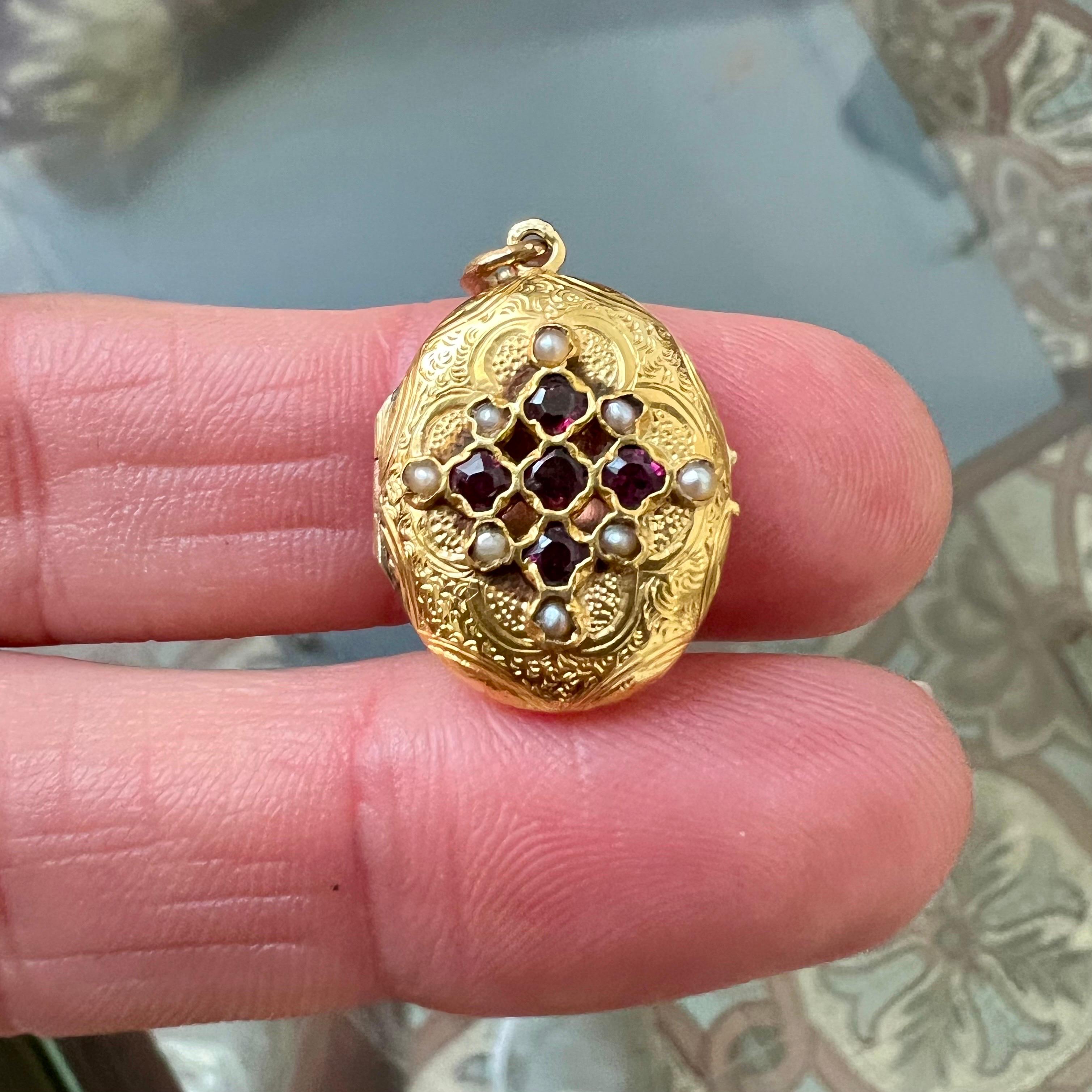 Ce pendentif médaillon ancien en or 14 carats est une pièce vraiment étonnante et rare, parfaite pour les collectionneurs de bijoux anciens. La face avant du pendentif présente un motif complexe en forme de diamant serti de grenats richement