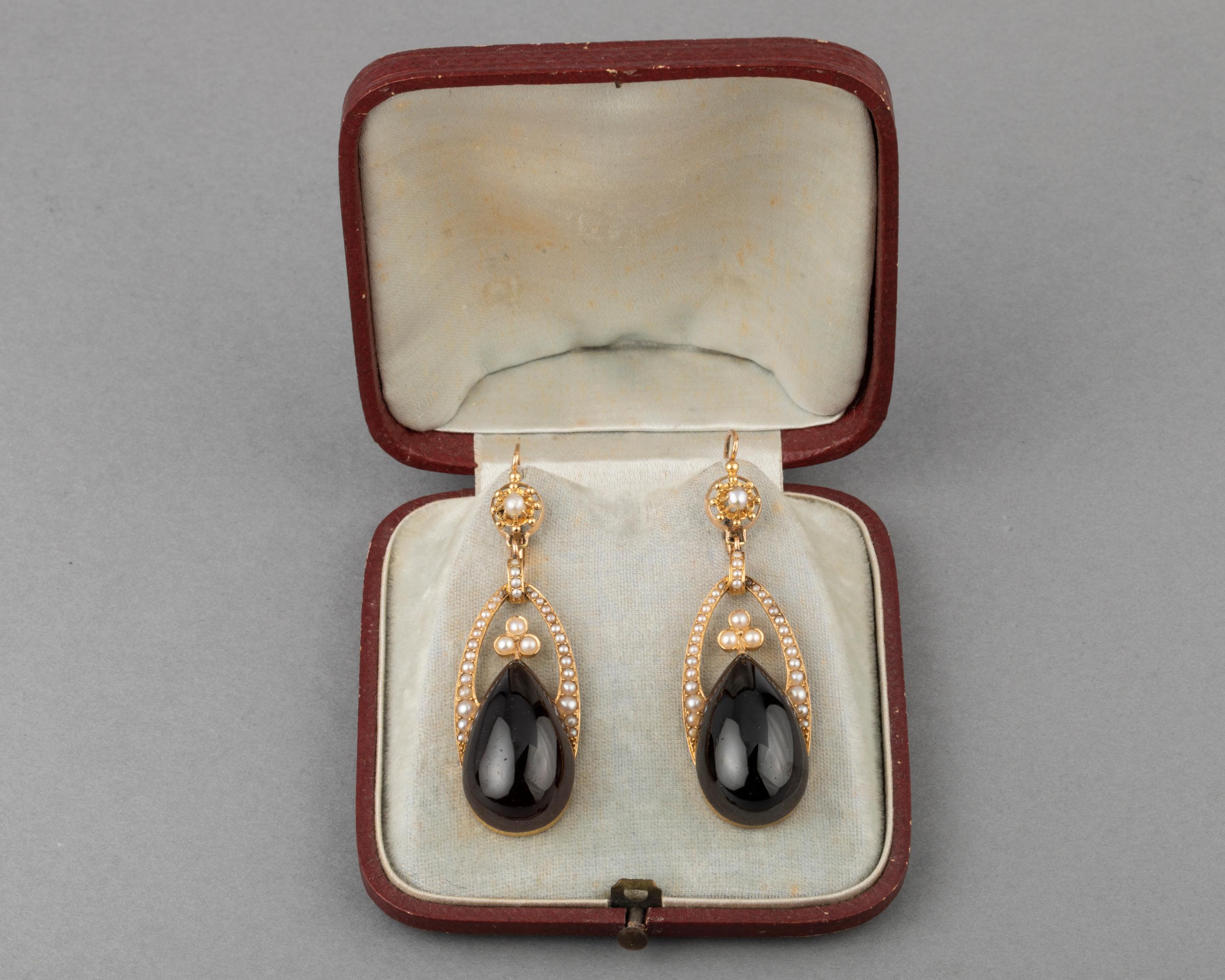 Antique God Garnets and Pearls Earrings

Very beautiful pair of antique earrings. French made circa 1870. They sit in their orignal boxe.
Made in rose gold 18k (two eagle head marks).  Set with two red garnets and titles fine pearls. They have