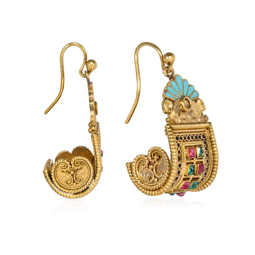 A pair of antique granulated gold earrings in the Egyptian revival style of scrolled design with a grid of emerald and rubies and pale blue enamel surmounts with twin sphinxes, in 18k.  See 