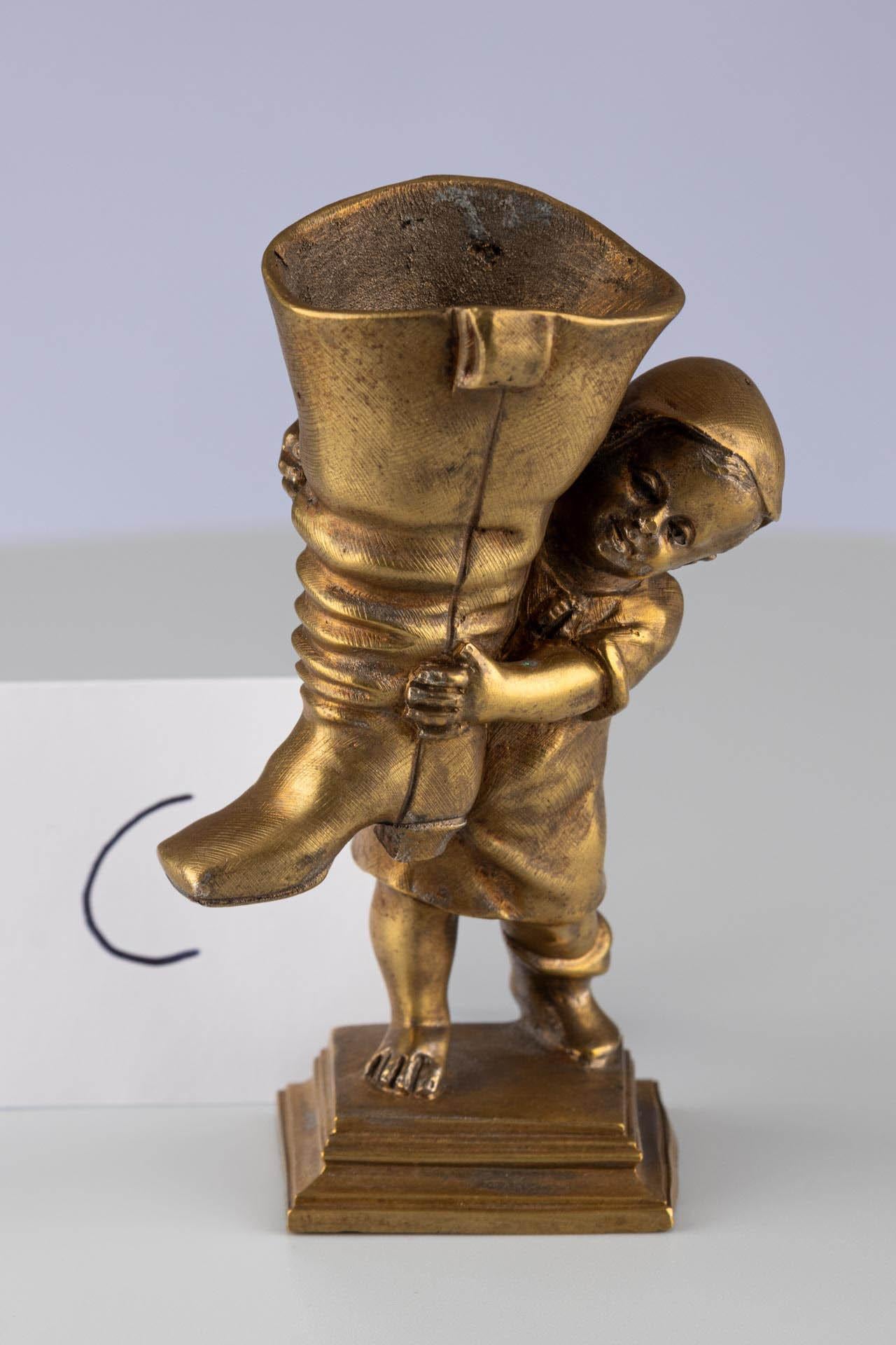 Antique Gold Gilt Bronze Ormolu Fairy Tale Inspired Match or Pen Holder 

Continental 
Bronze
c. 1900 

Dimensions: H x W x D: 10 x 6 x 6 cm 

This dainty antique is a match holder, its form paying homage to a beloved English fairy tale character