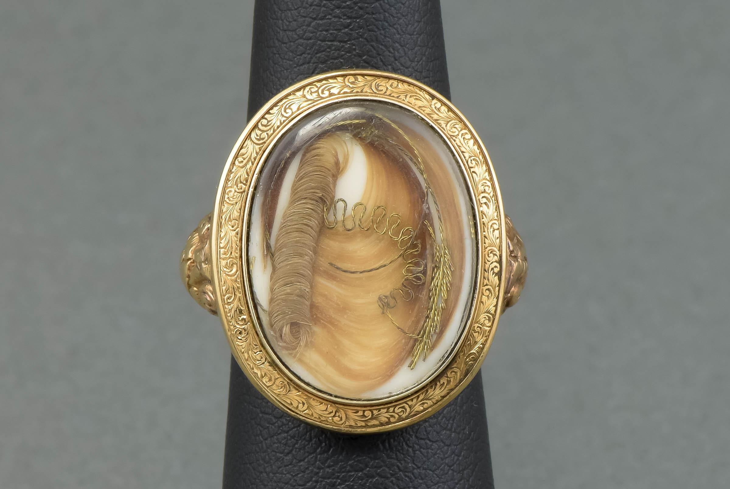 Dating to 1860, this lovely Victorian hair work ring was likely once a sentimental or mourning brooch or pendant. At some point in the Victorian period it was converted into the lovely ring it is now.

Crafted of gold testing between 10K and 14K,