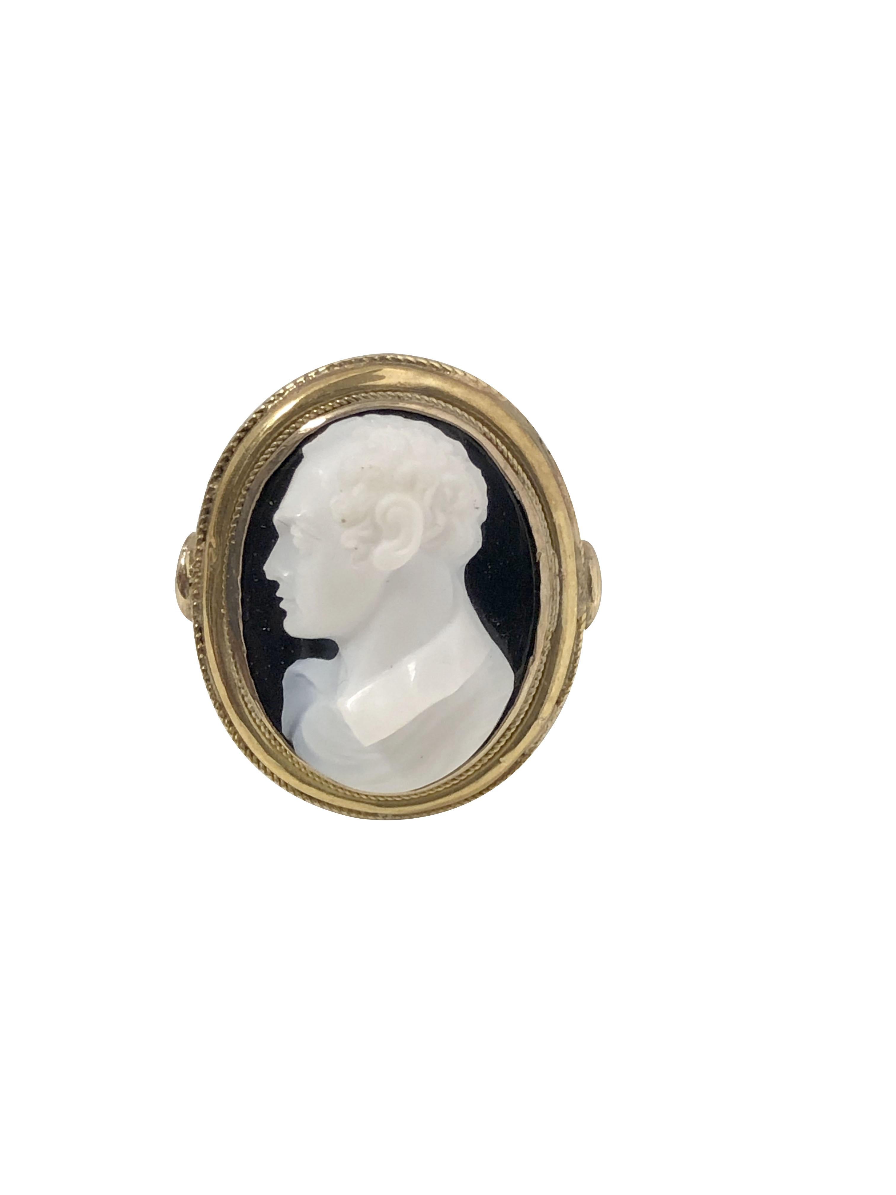 Circa 1880s Hard Stone Cameo Ring, having a very finely carved dimensional Sardonyx stone in a profile of a Gentleman, the top of the ring measures 7/8 X 3/4 inch. Cut out under gallery work and having a newer shank. Finger size 6