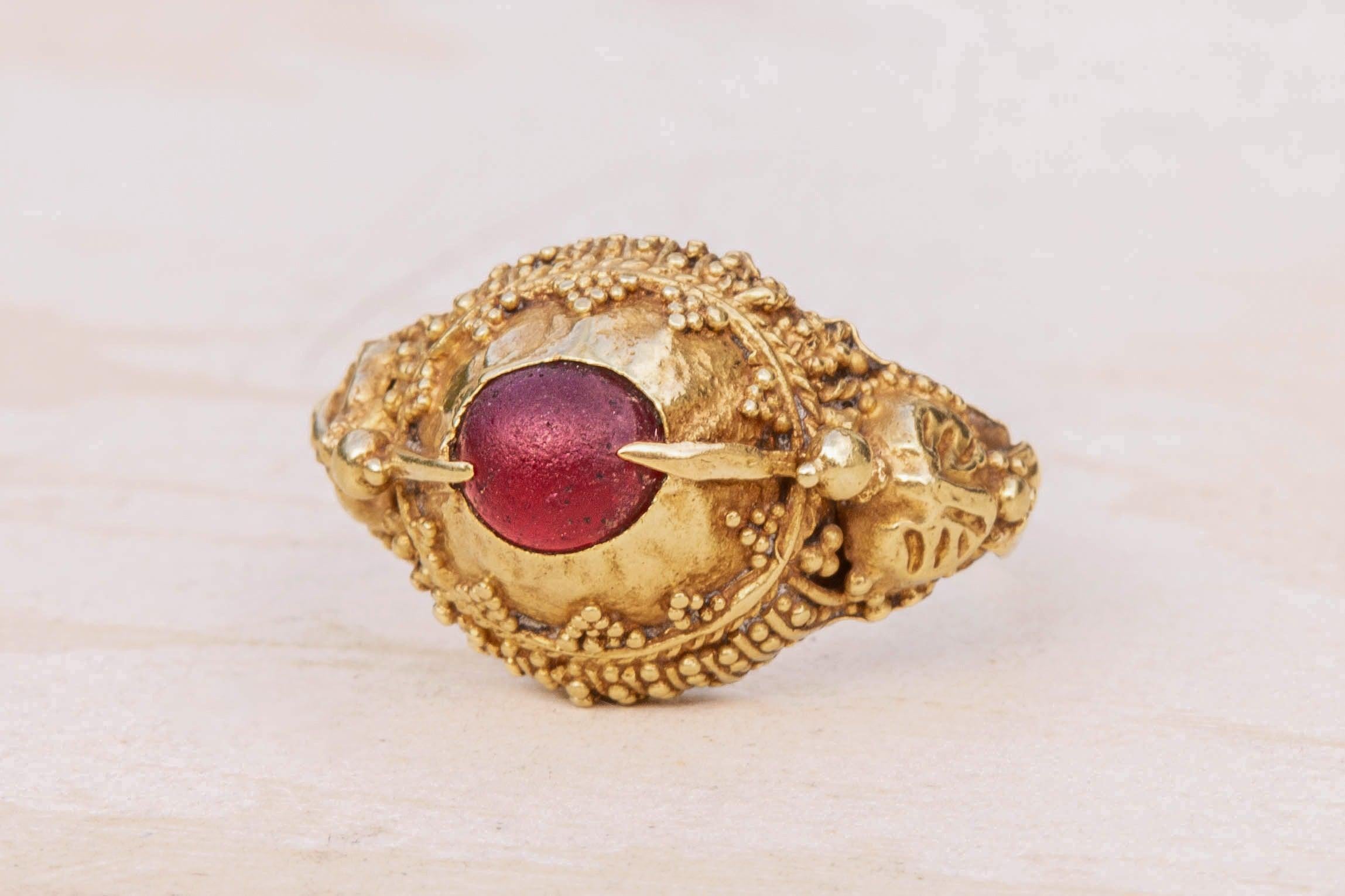 A scarce late 19th century gold ‘priest’s ring’ from the island of Bali, Indonesia.

The ring is a fantastic example of the southern Balinese style, where the shoulders are decorated with hummingbirds. The birds' beaks serve as prongs to hold the