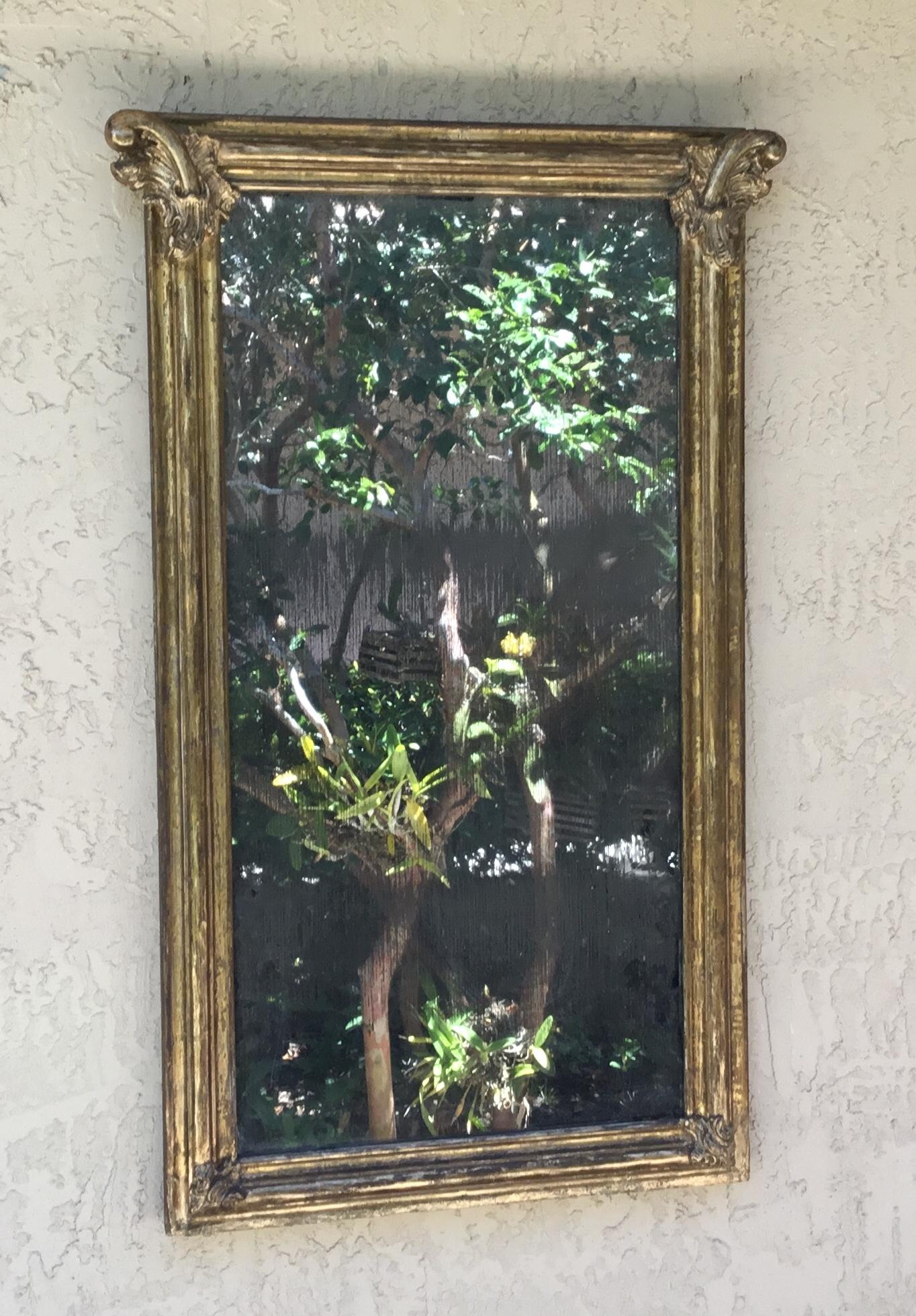 Elegant antique mirror made of wood, straight line, decorative molding on each corner, originally
Gold leaf although due the age and time some of it undergone some restoration. The mirror plate itself is original and mercury silvered distress with