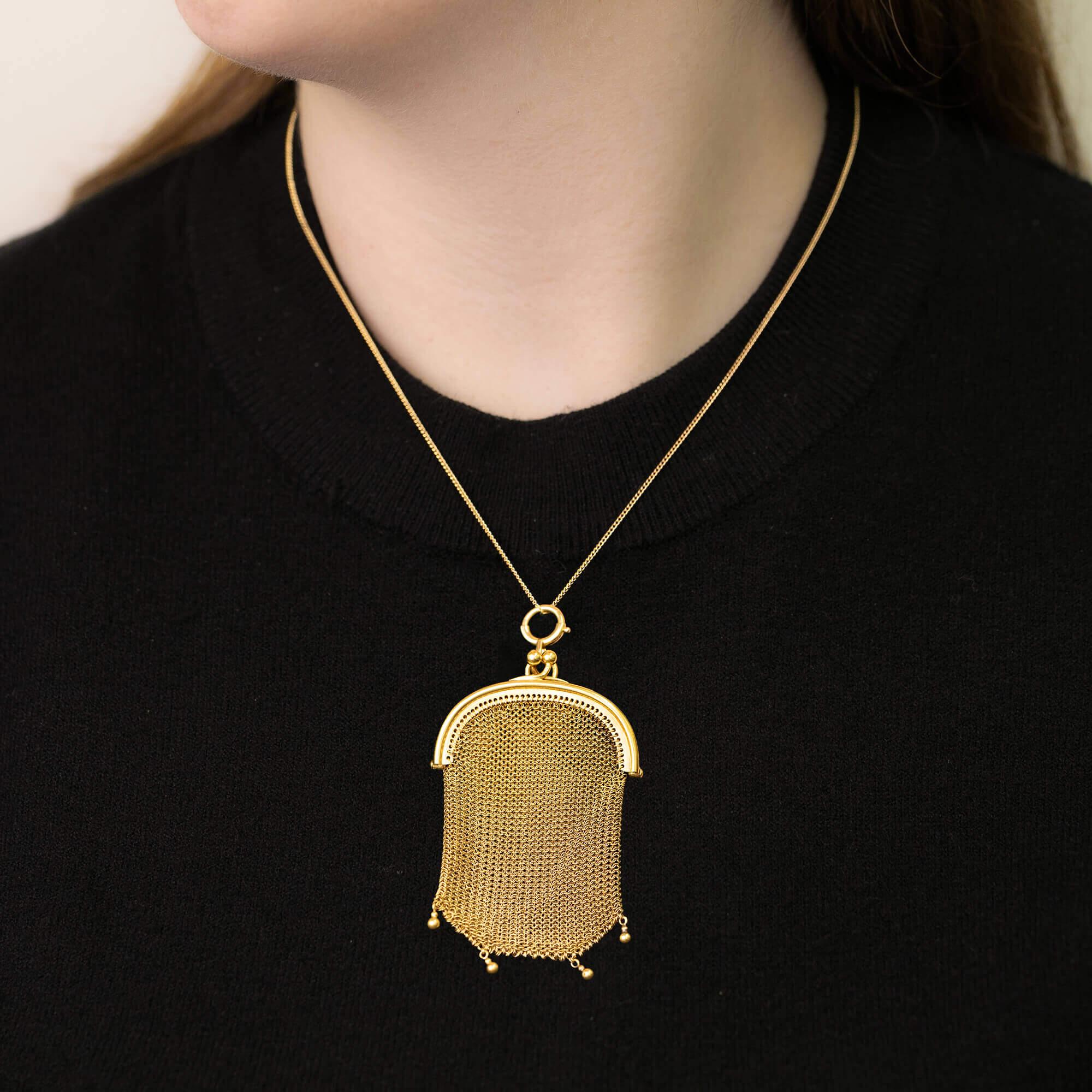 This beautiful French made purse is in fine condition with no broken or missing links. Crafted in gilded 18k yellow gold featuring a fine mesh chain-mail body with ball pendant details at the base and finished with a hinged polish top with a snap