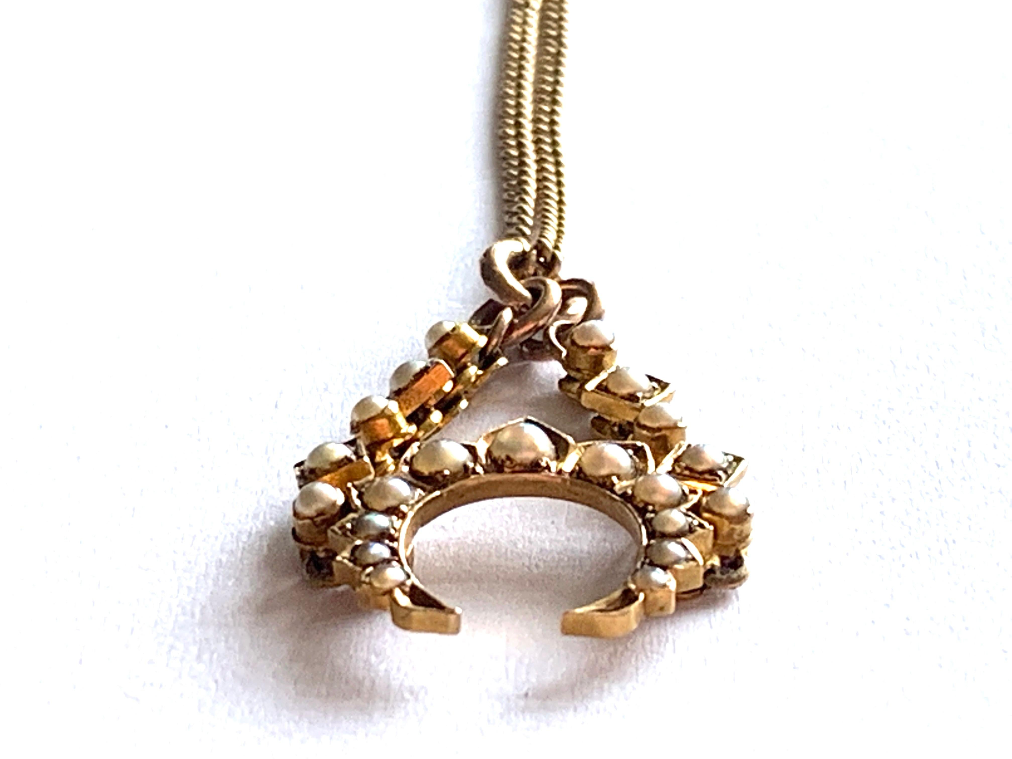 Beautiful Antique Necklace 
Consists of  stunning pearl 22ct gold pendant 
The central arc swings freely
on a 9ct gold antique Chain 
the chain has a 9c plaque  near the end jump ring.

Pendant size 2.5 cm x 1.5 cm
Pendant weight 2.34 grammes
Chain