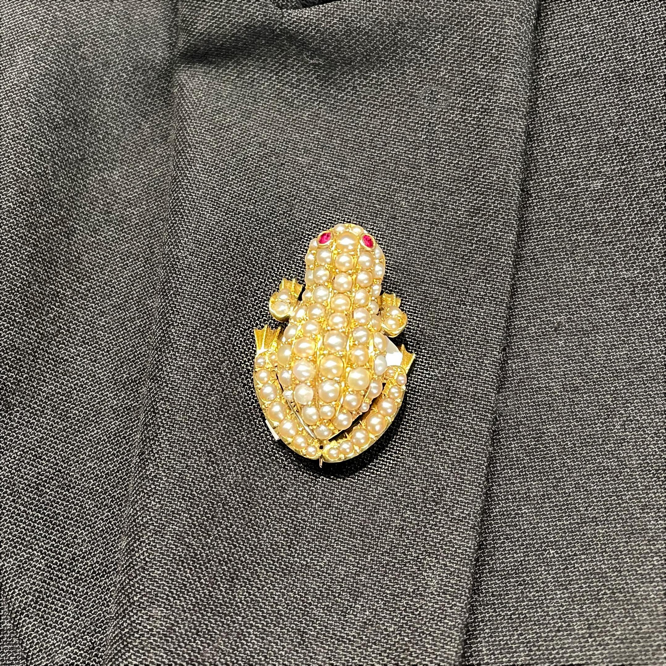 A late Victorian pearl frog brooch, set with natural seed pearls and cushion-cut ruby eyes, mounted in 18ct yellow gold, with an 18ct stamp, English, circa 1900.