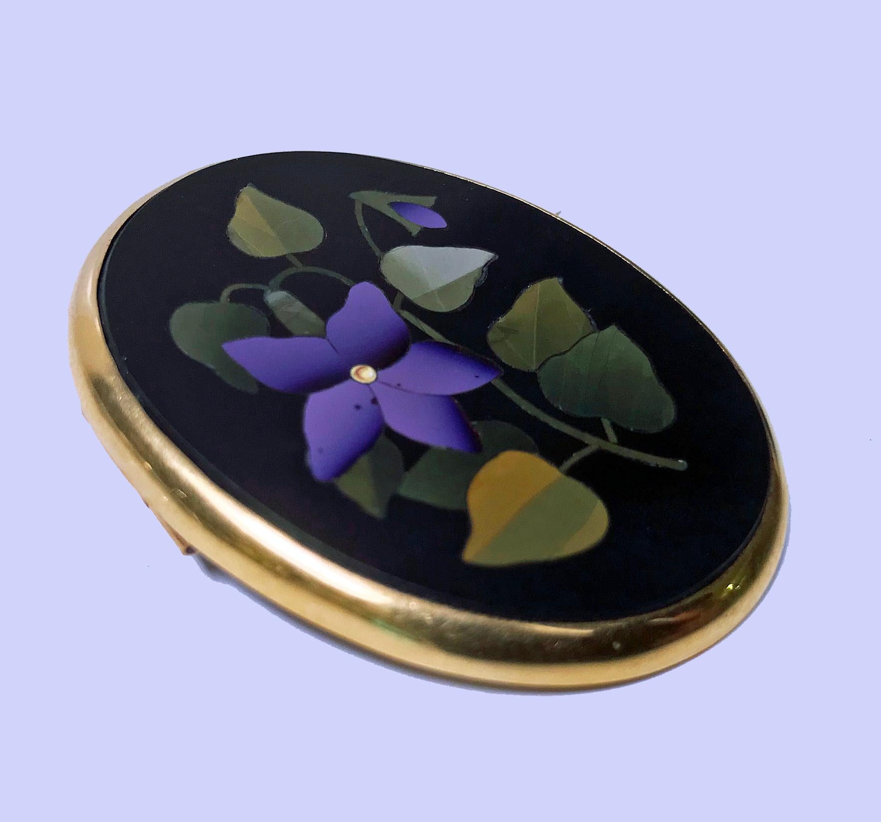 Antique 18 karat gold Pietra Dura brooch, Italy, circa 1875. Oval shape, fine Pietra Dura floral green, lilac inlay colors, 18 karat surround gold mount. Gold acid tests 18 karat. Measures: 1.75 x 1.50 inches. Total Item Weight: 13.36 grams.

 