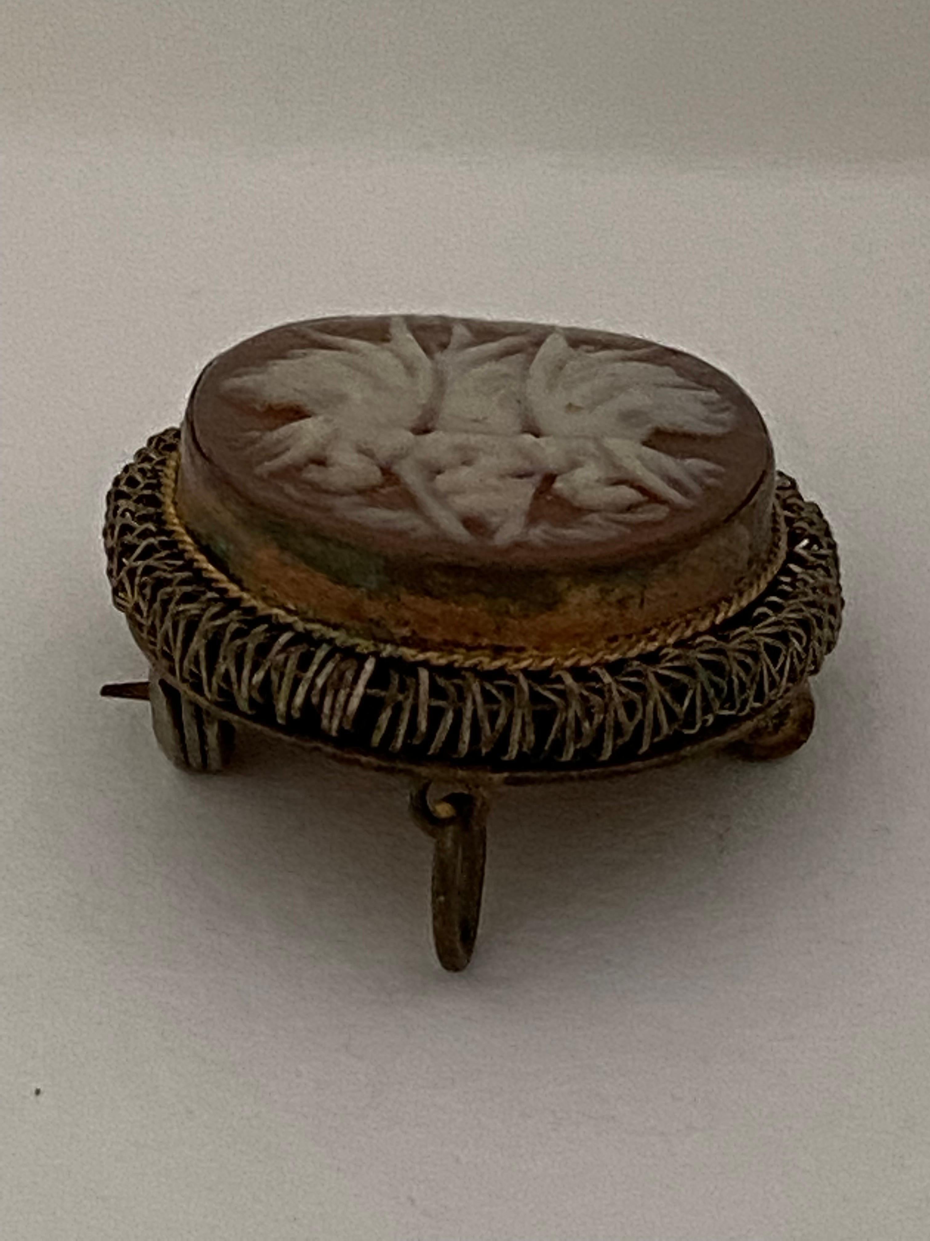 This beautiful antique piece is in good condition for its age. Visible signs of ageing and wear. some tarnishes on the back as shown and dents as shown. It can be as pendant necklace or can be wear as brooch. It is 30mm long by 25mm wide diameter.