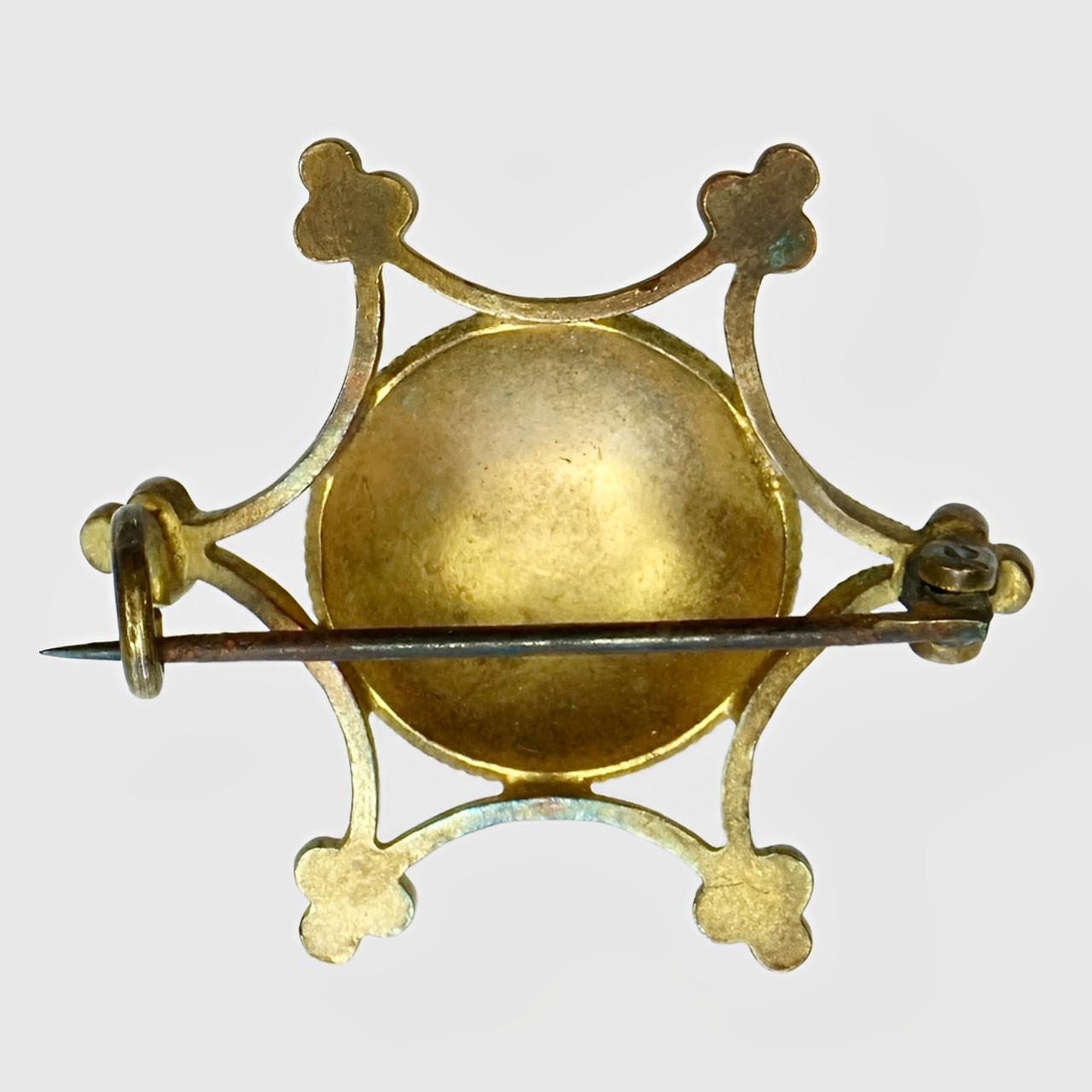 Precioso broche antiguo chapado en oro con decoración de esmalte azul pálido y blanco. Tiene un cierre de gancho en 