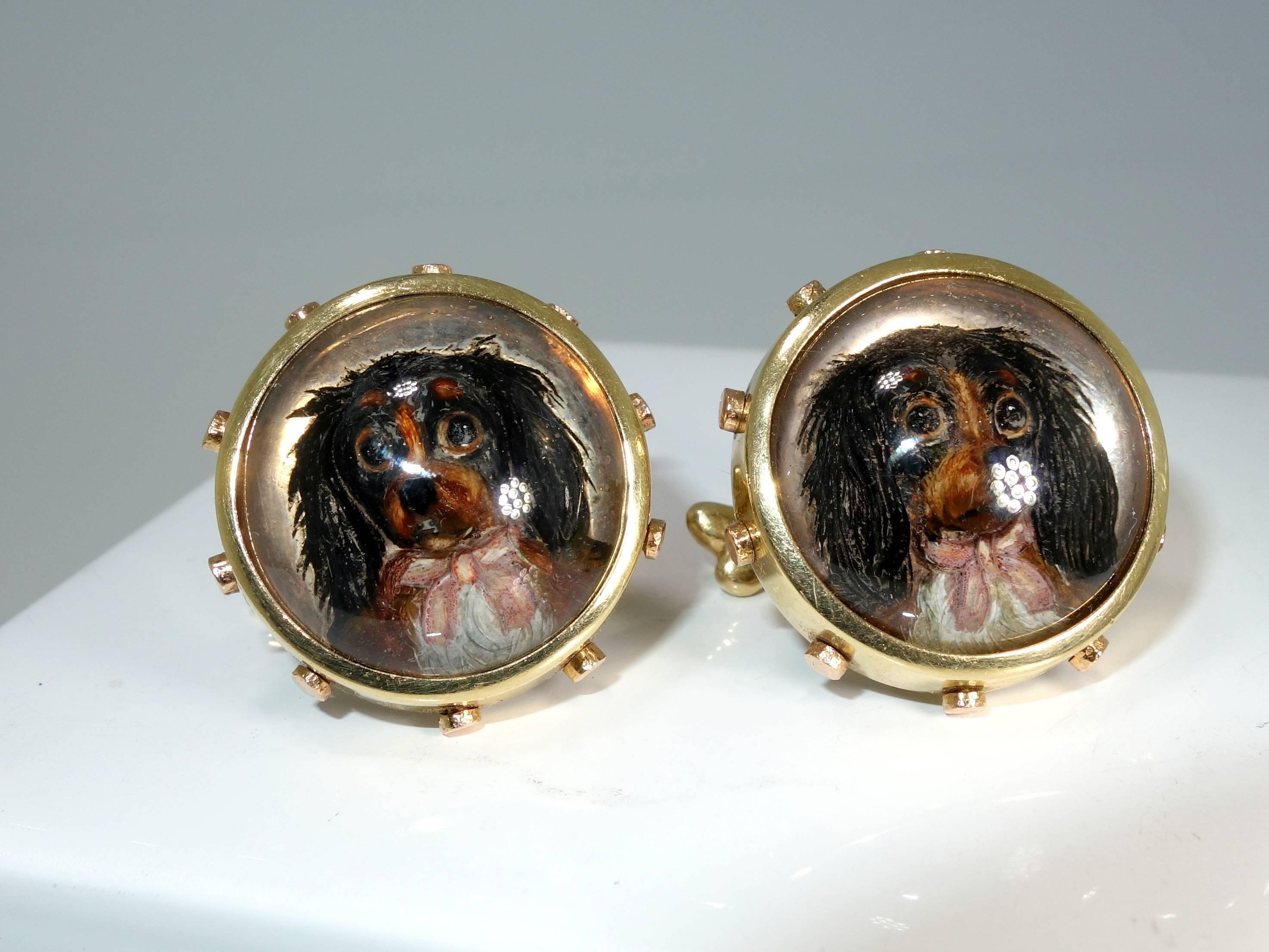 Late 19th Century reverse painting under rock crystal, these finely painted dogs brimming with personality was made circa 1890.  In both yellow and rose gold,  notice the dog bone on the other side of the 