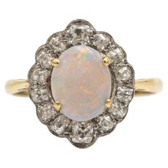 Antique gold ring with opal and 1.00 ct diamonds, early XX cent.