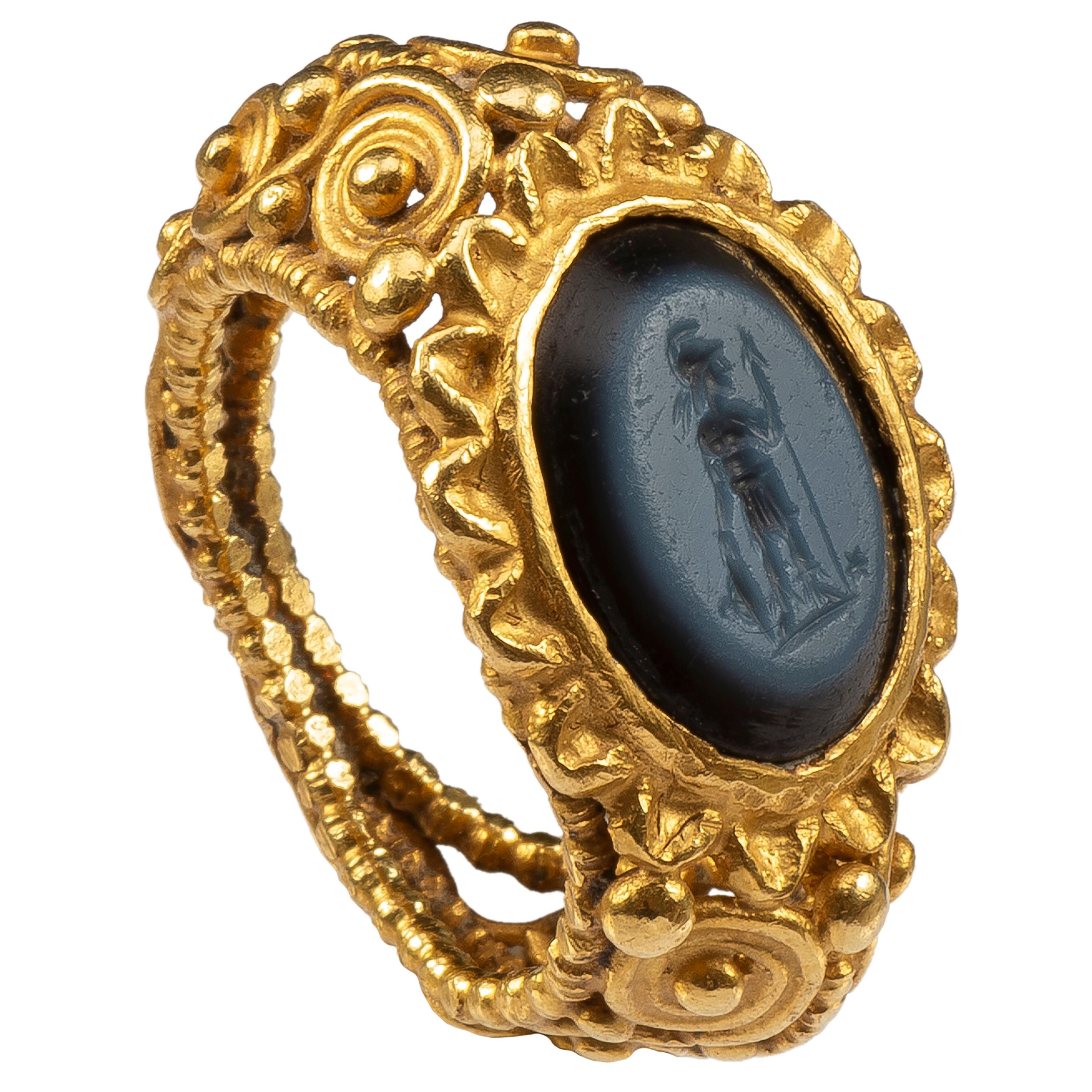 Roman Ring with Intaglio of Mars 
Roman, 4th century AD, intaglio 3rd century AD
Gold, nicolo
Weight: 15.3 gr.; Circumference: 49.32 mm.; US size 5; UK size J ½

This deceptively heavy gold ring consists of a hoop made of filigree wires. A central