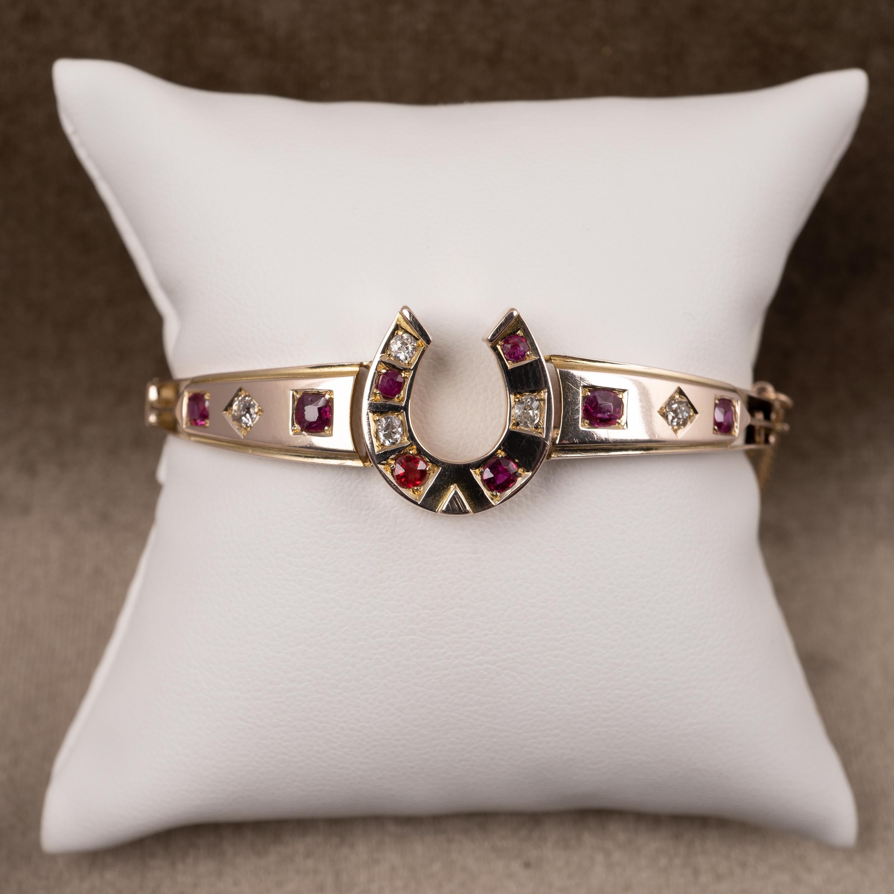 This fabulous antique bangle features European cut diamonds and natural rubies totalling an impressive 1.75 carats. A fabulous collector's piece.

The bangle opens with ease by way of easy trigger catch and the is a small gold safety chain to ensure