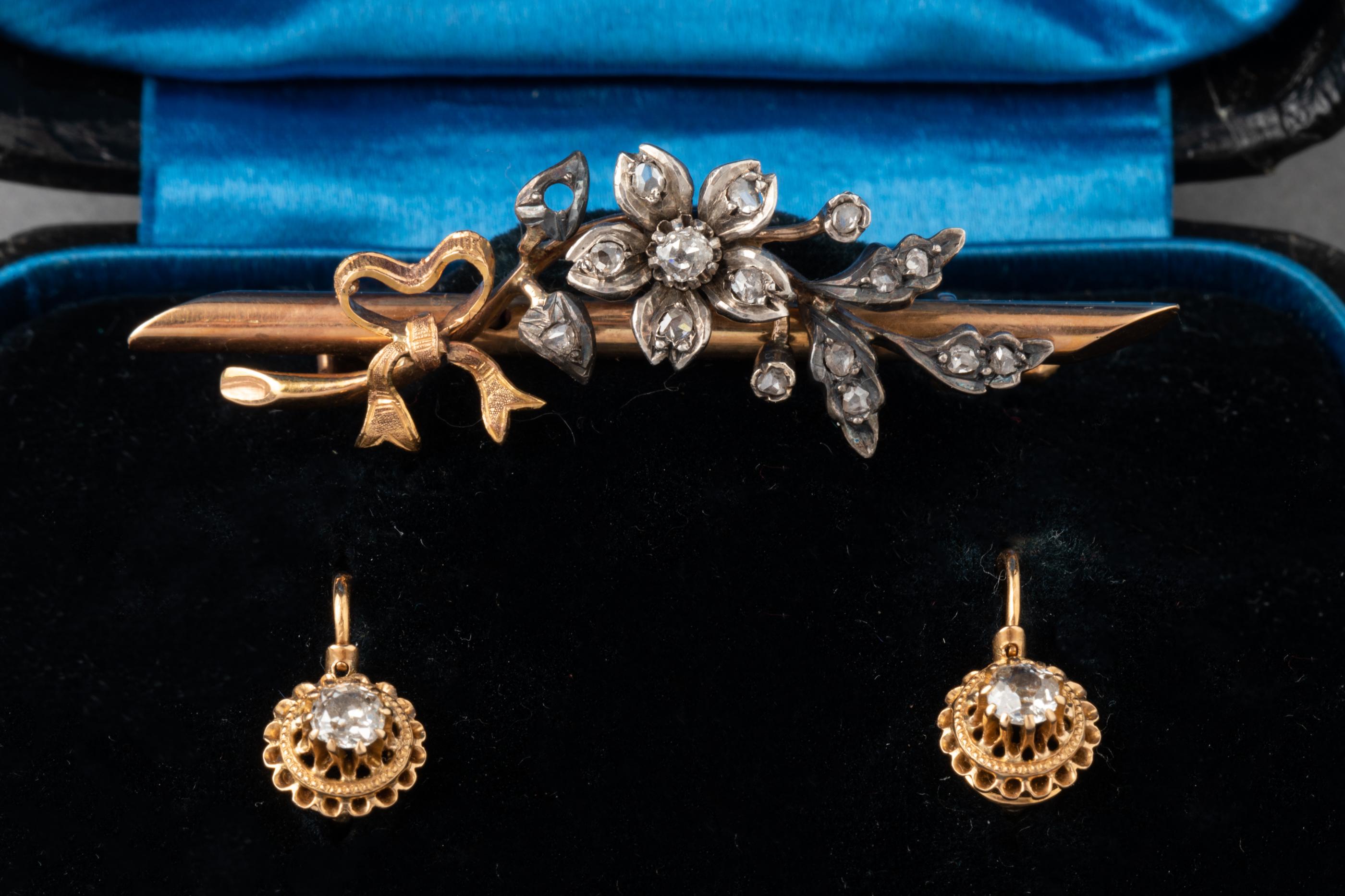 Antique Gold Silver and Diamonds Earrings and Brooch

Beautiful set in original boxe, made in France circa 1870.
The brooch measures 5 cm, the earrings 1.5 cm.
Made in yellow and rose gold 18k, silver and diamonds. The diamonds are old european cut