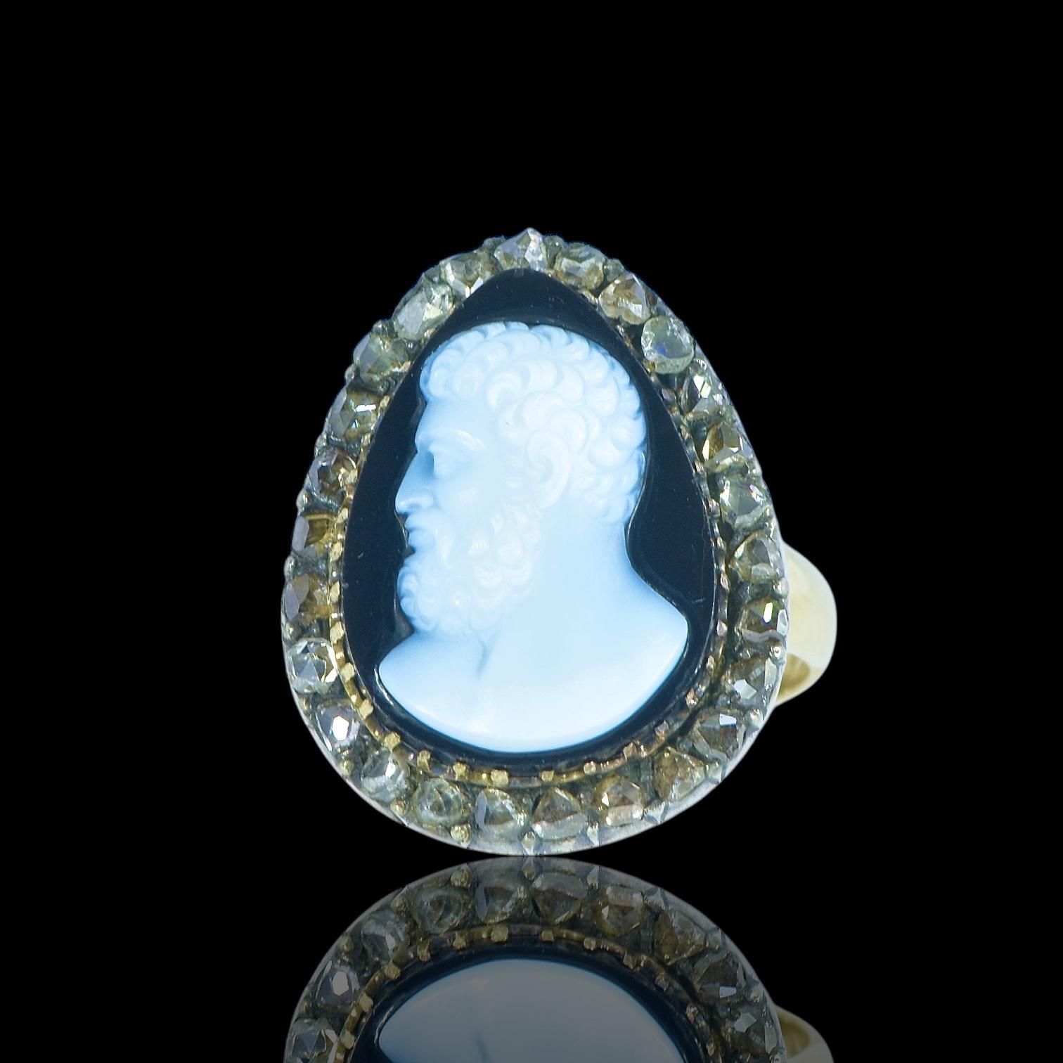 It is such a delight when we discover a small but scintillating treasure! This is an antique hardstone cameo with a naturalistic shape in the form of a halo of rose cut diamonds surrounding a gentleman all of which is set in silver and backed in