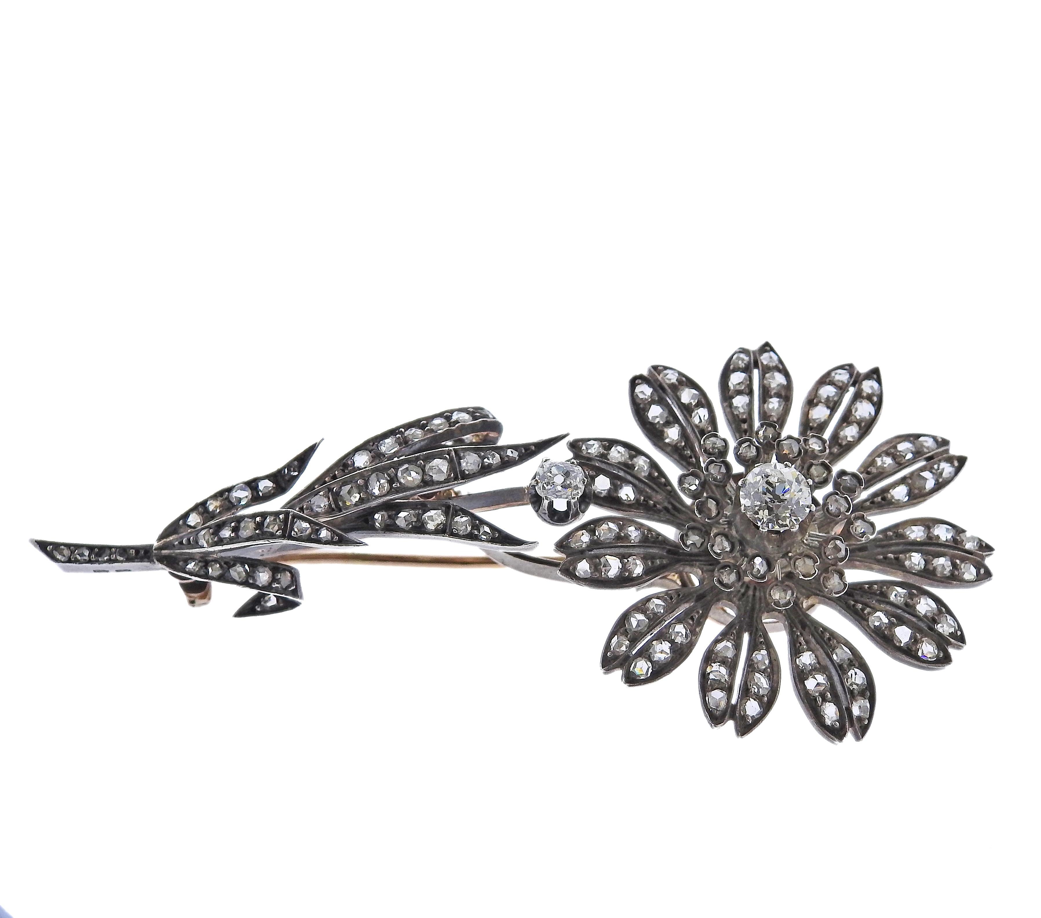 Antique gold and silver floral brooch, with rose and old mine cut diamonds. Brooch is 67 x 31mm. Weight 16.6 grams. 