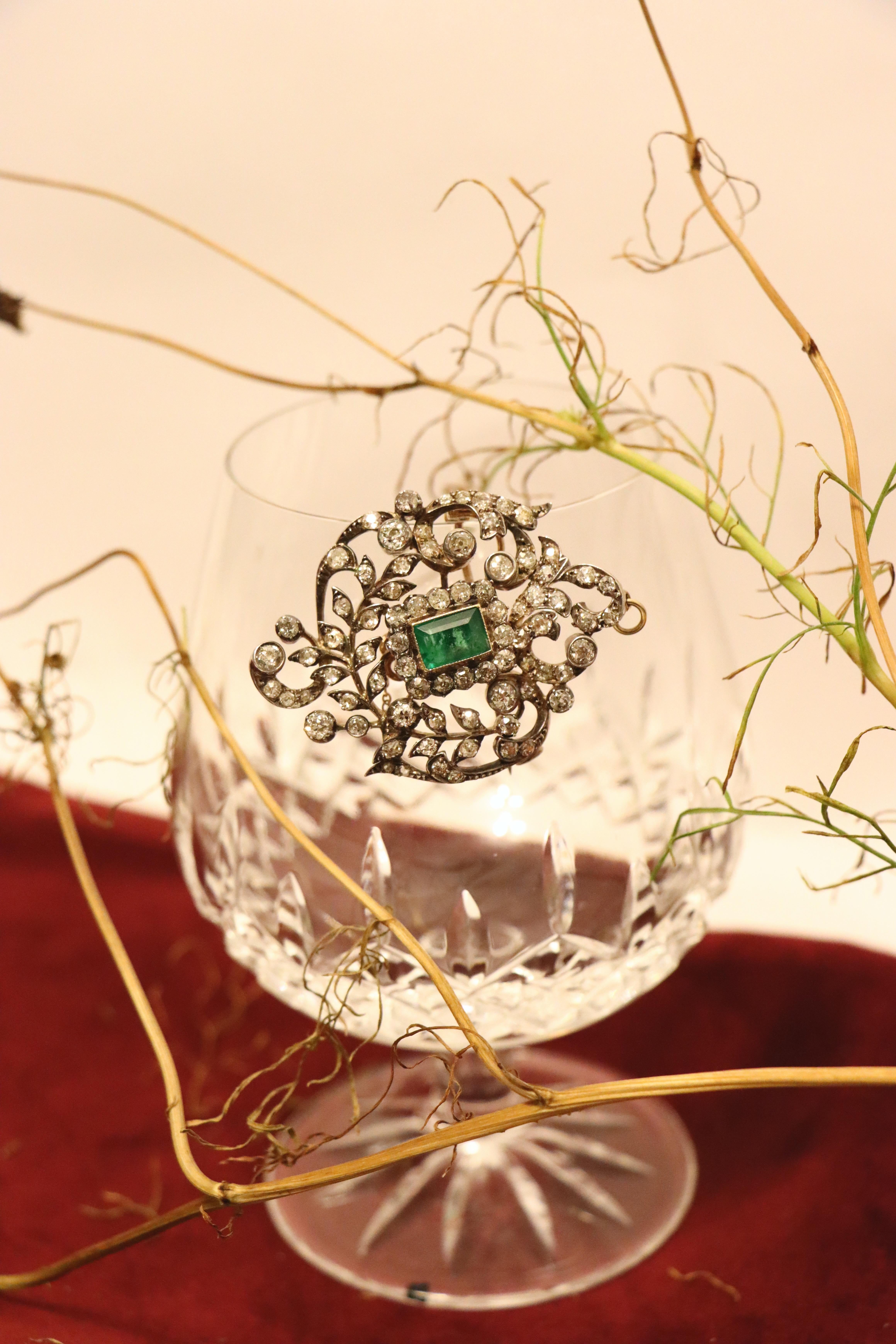 Antique Gold & Silver Emerald Diamonds Pendant Brooch

Approximate Dimensions:
5.5 cm (Length) 
3.8 cm (Width)
4 carats (Diamond)
1.5 carats (Emerald)
18.2 grams in weight.