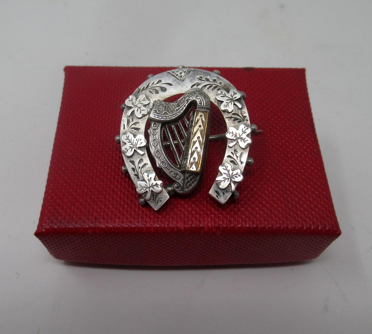 Stylish example of a Lady’s well cast Sterling Silver antique pin Brooch of medium size made during the last quarter of the Nineteenth Century. 

The central reserve depicts an Irish Harp with a gold embossed bar all surrounded with a most