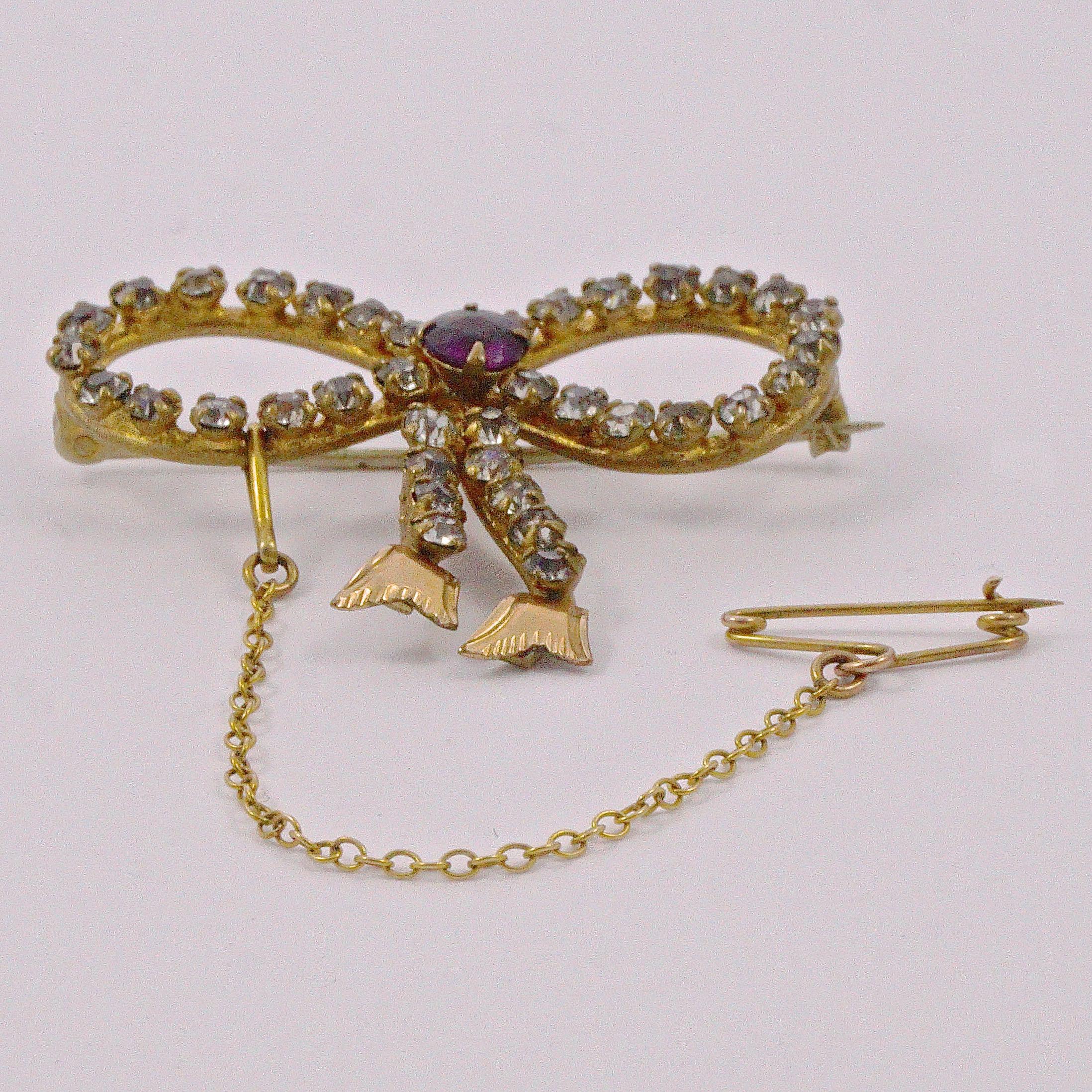 Women's or Men's Antique Gold Tone Amethyst and Clear Paste Bow Brooch circa 1910 For Sale